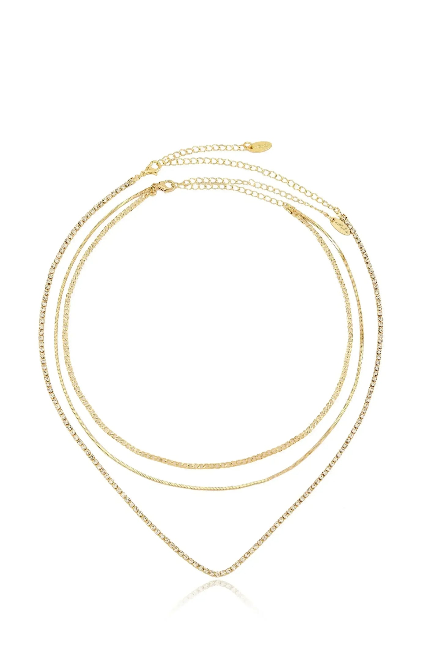 A three-strand gold necklace with varying textures, including a sparkling chain, drapes elegantly in a V shape, reflecting on a clean, white background that enhances its shine.