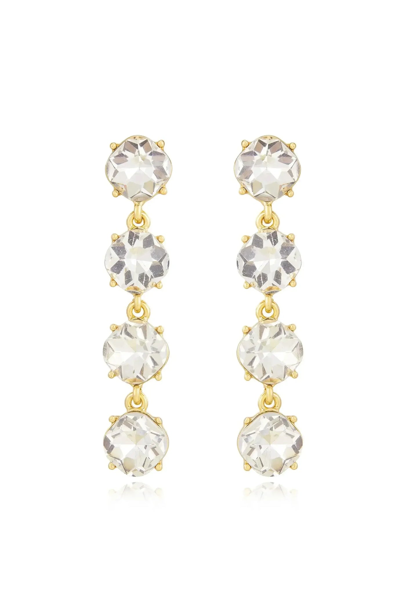 Two elegant golden drop earrings with three sparkling clear crystals each hang vertically. They are designed to add sophistication and shine, suitable for formal or festive occasions.