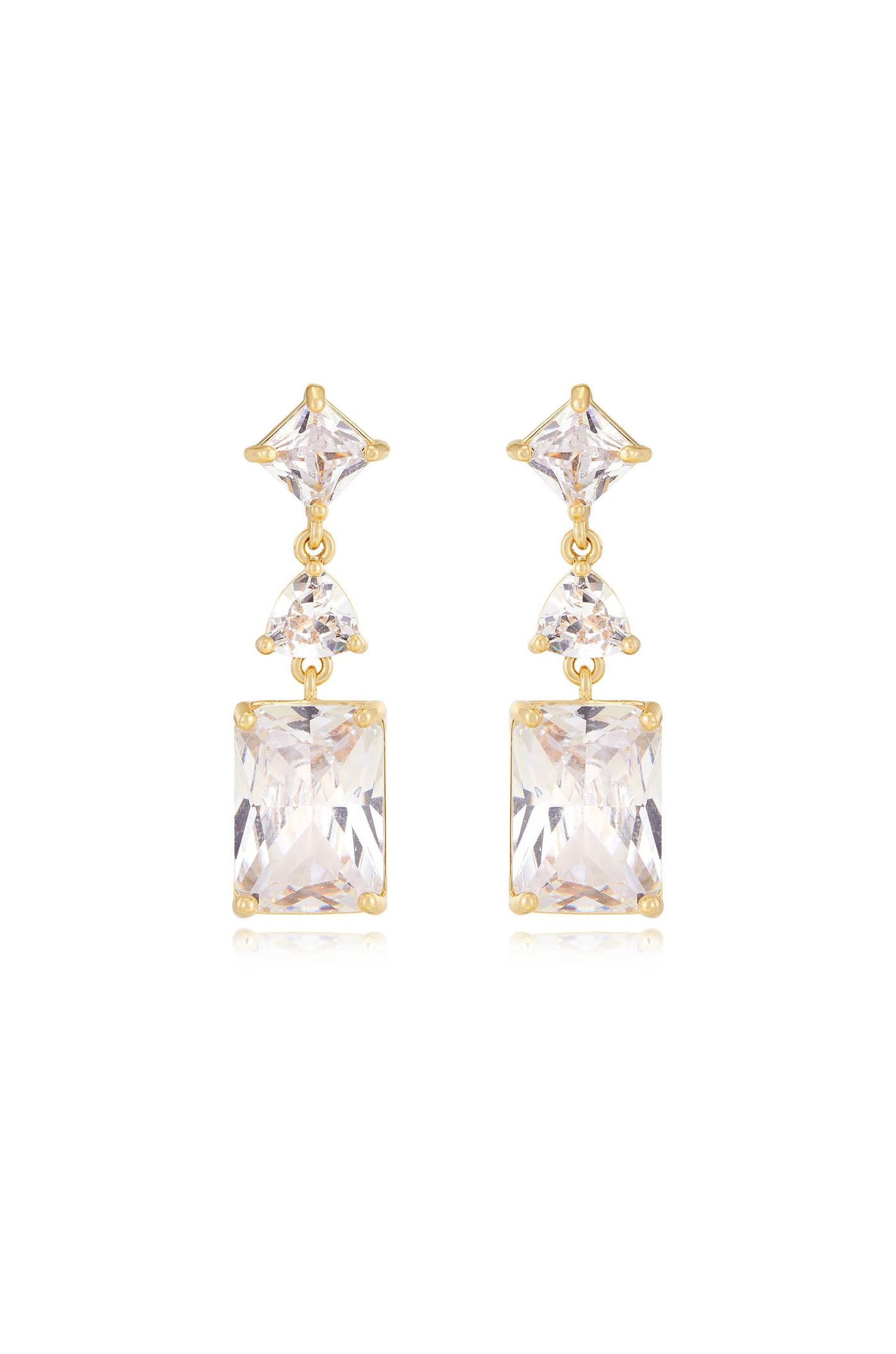 Gold earrings featuring a symmetrical design comprise an upper triangular gemstone, a smaller round gemstone, and a larger rectangular gemstone, reflecting light against a neutral background.