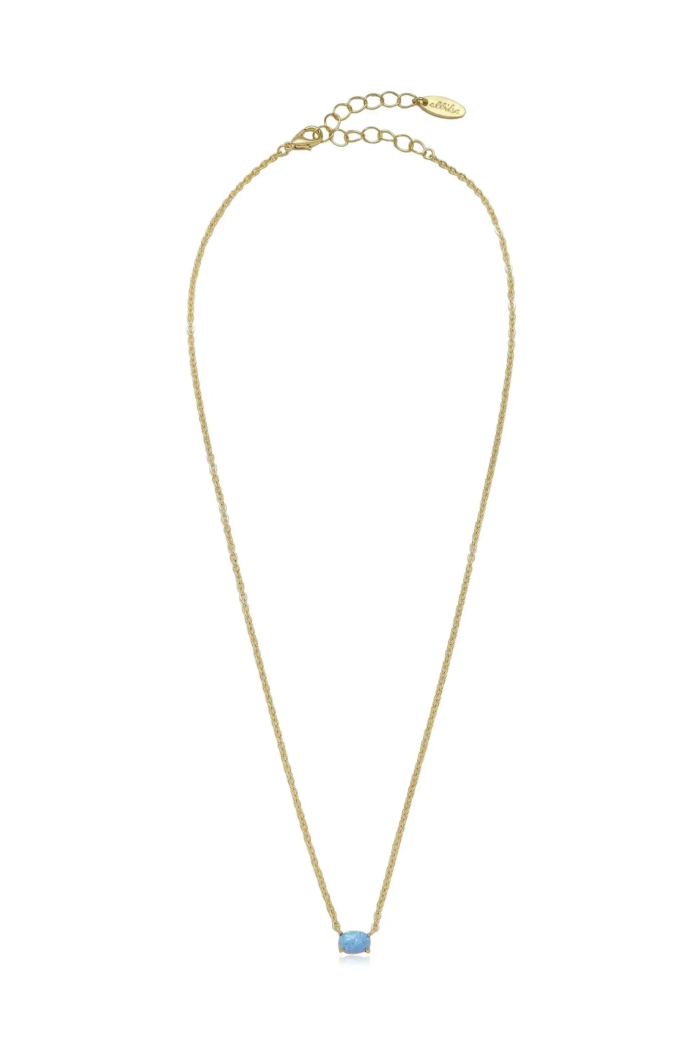 A delicate golden necklace features a thin, twisted chain with a single light blue gemstone at its center, against a simple white background, highlighting its elegance.