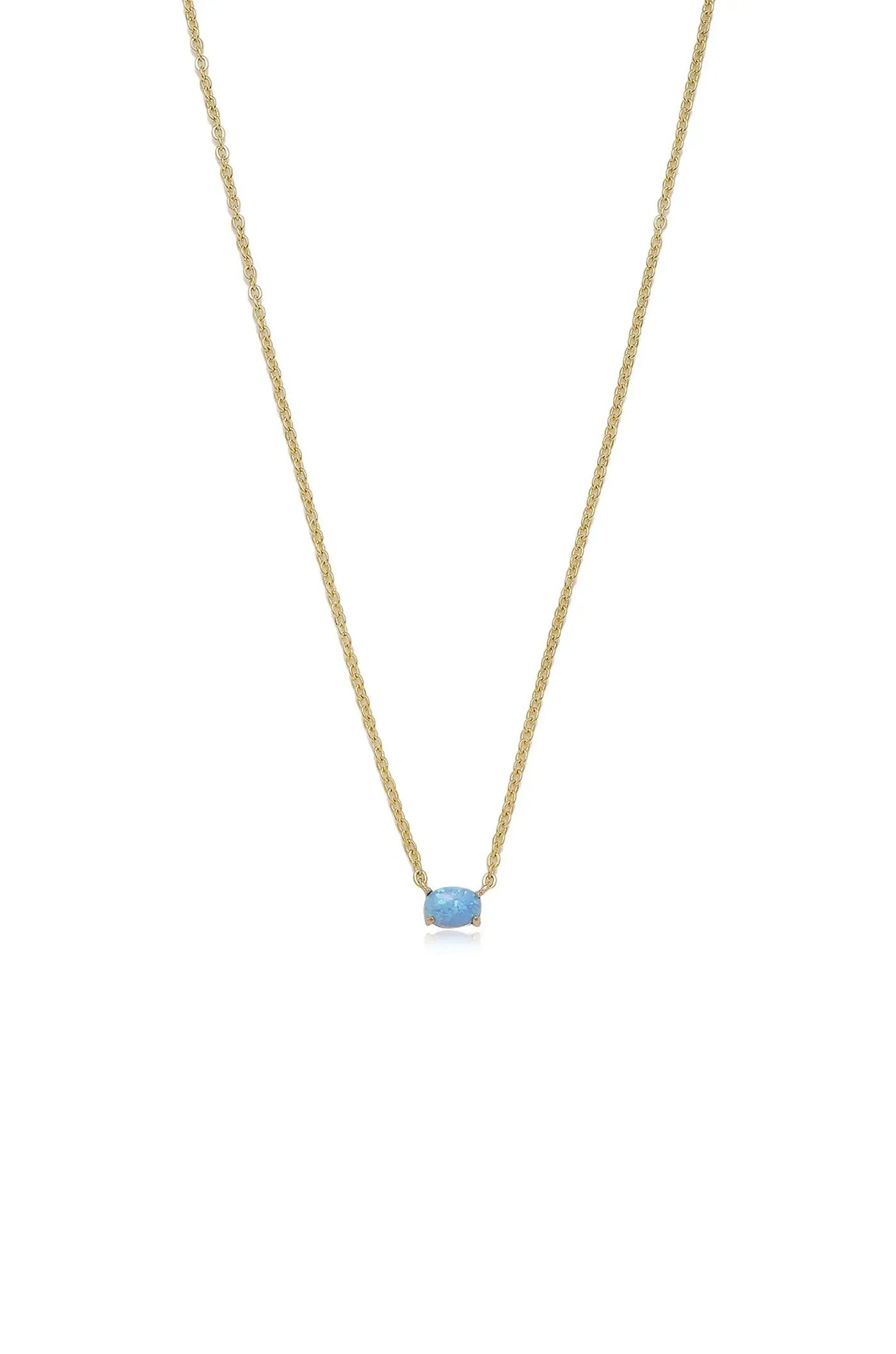 A gold necklace with a simple, delicate chain features a prominent light blue opal pendant centered on it, displayed against a plain white background.
