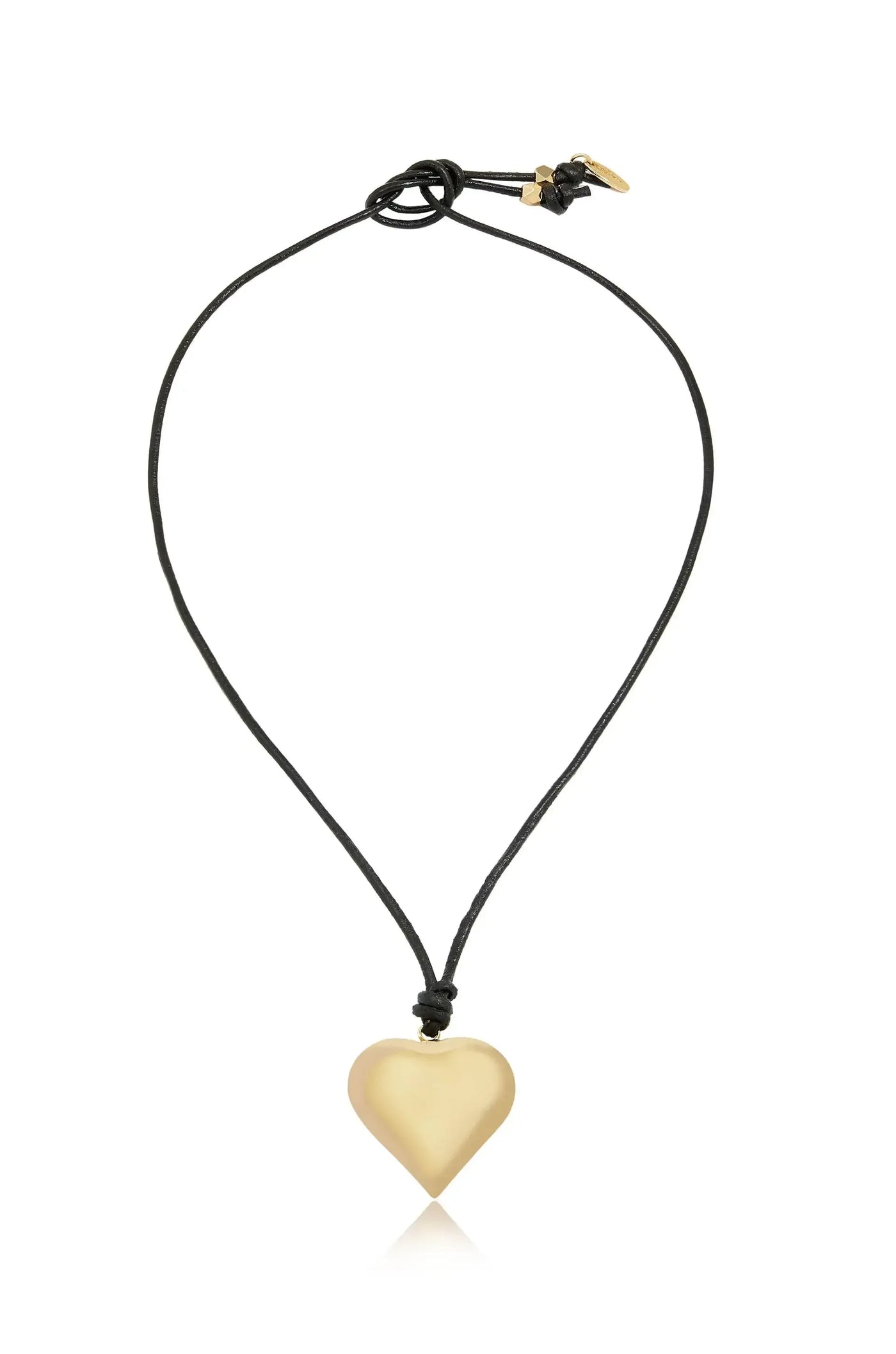 A gold heart-shaped pendant hangs from a black cord, creating a simple yet elegant necklace. The pendant reflects light, enhancing its smooth, shiny surface against a plain background.