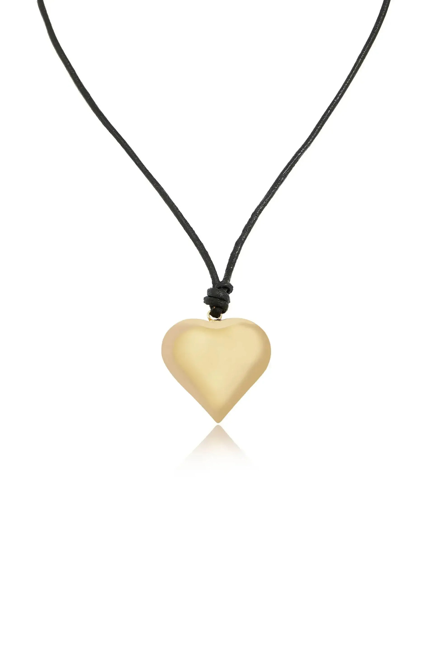 A heart-shaped pendant made of smooth, shiny material hangs from a black cord, reflecting light against a plain, white background. It exudes a simple, elegant design.