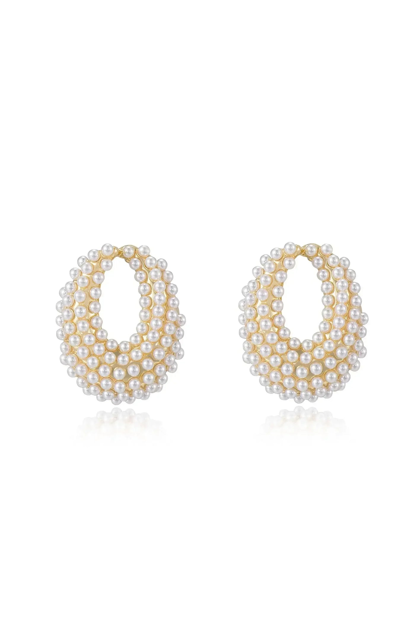 Two large hoop earrings, adorned with multiple small pearls arranged in layers, showcase a reflective surface and a golden outline, set against a simple, light background.