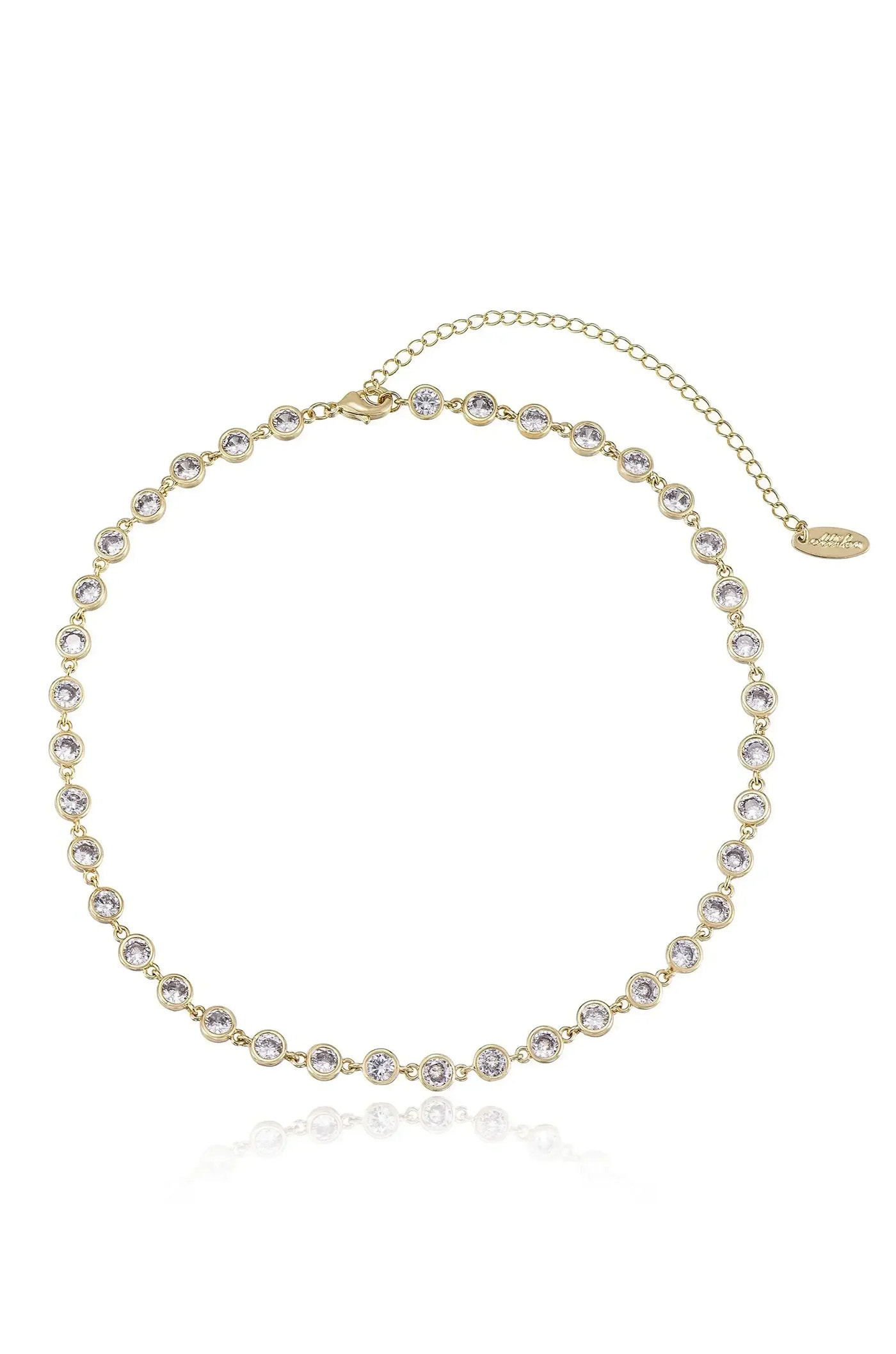 A gold choker necklace adorned with numerous sparkling stones is displayed against a reflective surface, showcasing its elegant design, ideal for formal occasions or enhancing everyday attire.