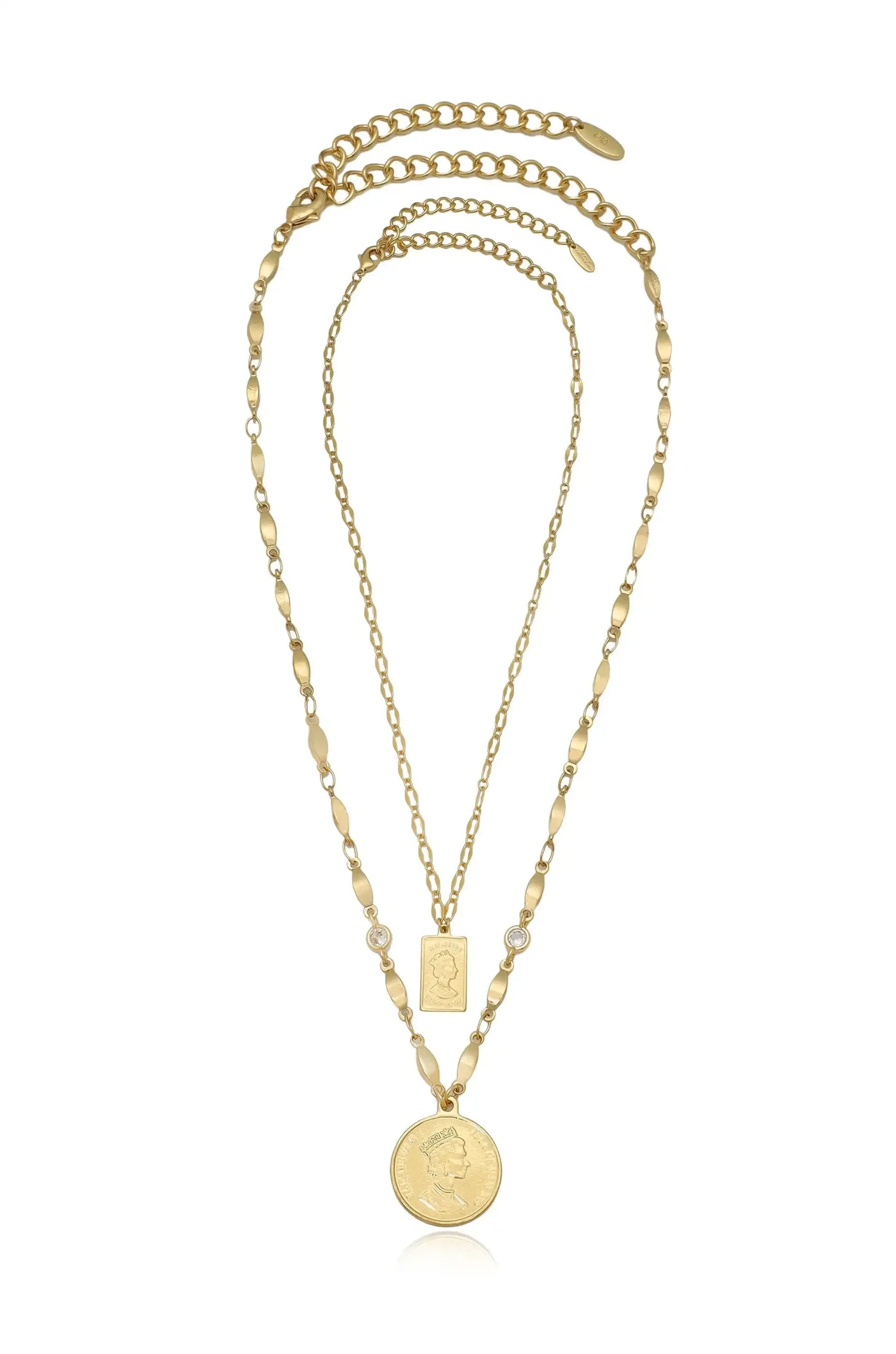 A layered gold necklace featuring three chains; one with a circular pendant depicting a figure, another adorned with a rectangular charm, both accented by small stones.