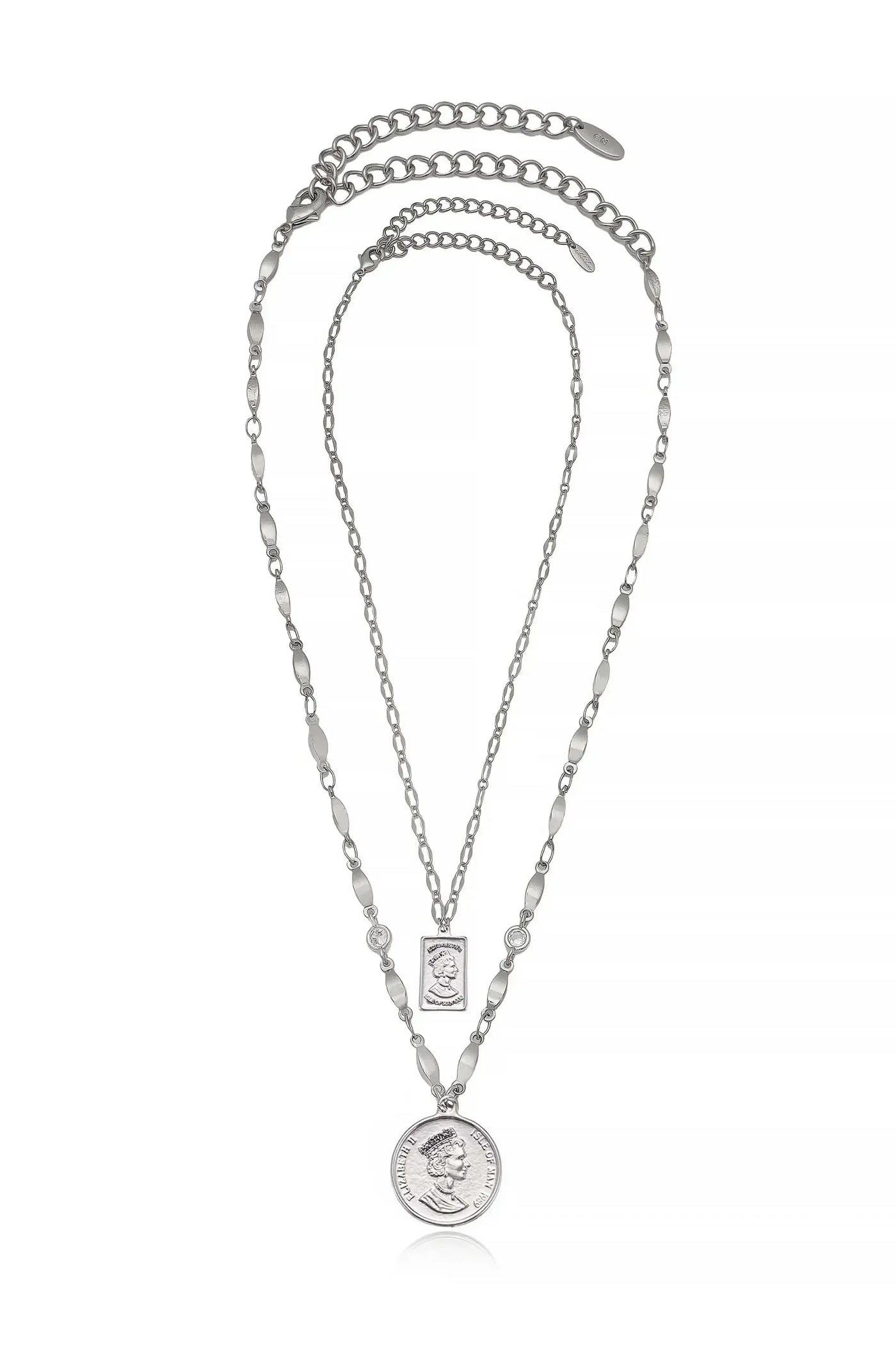 A silver necklace features three layered chains. The longest chain displays a round pendant with a profile of a queen, while a smaller rectangular charm above it complements the design.