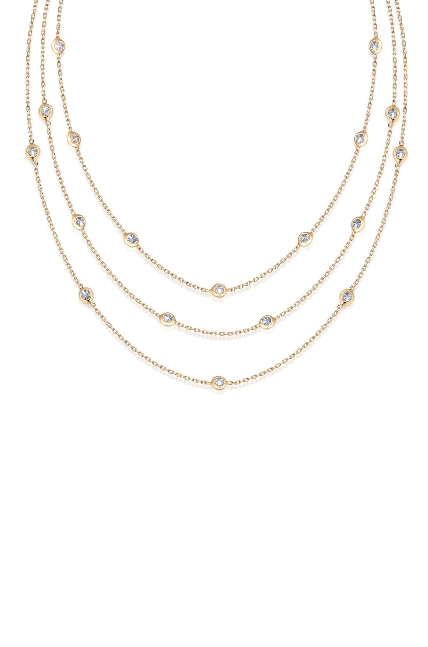 A layered gold necklace adorned with evenly spaced, circular gems rests against a plain white background, highlighting its elegant design and shimmering details.