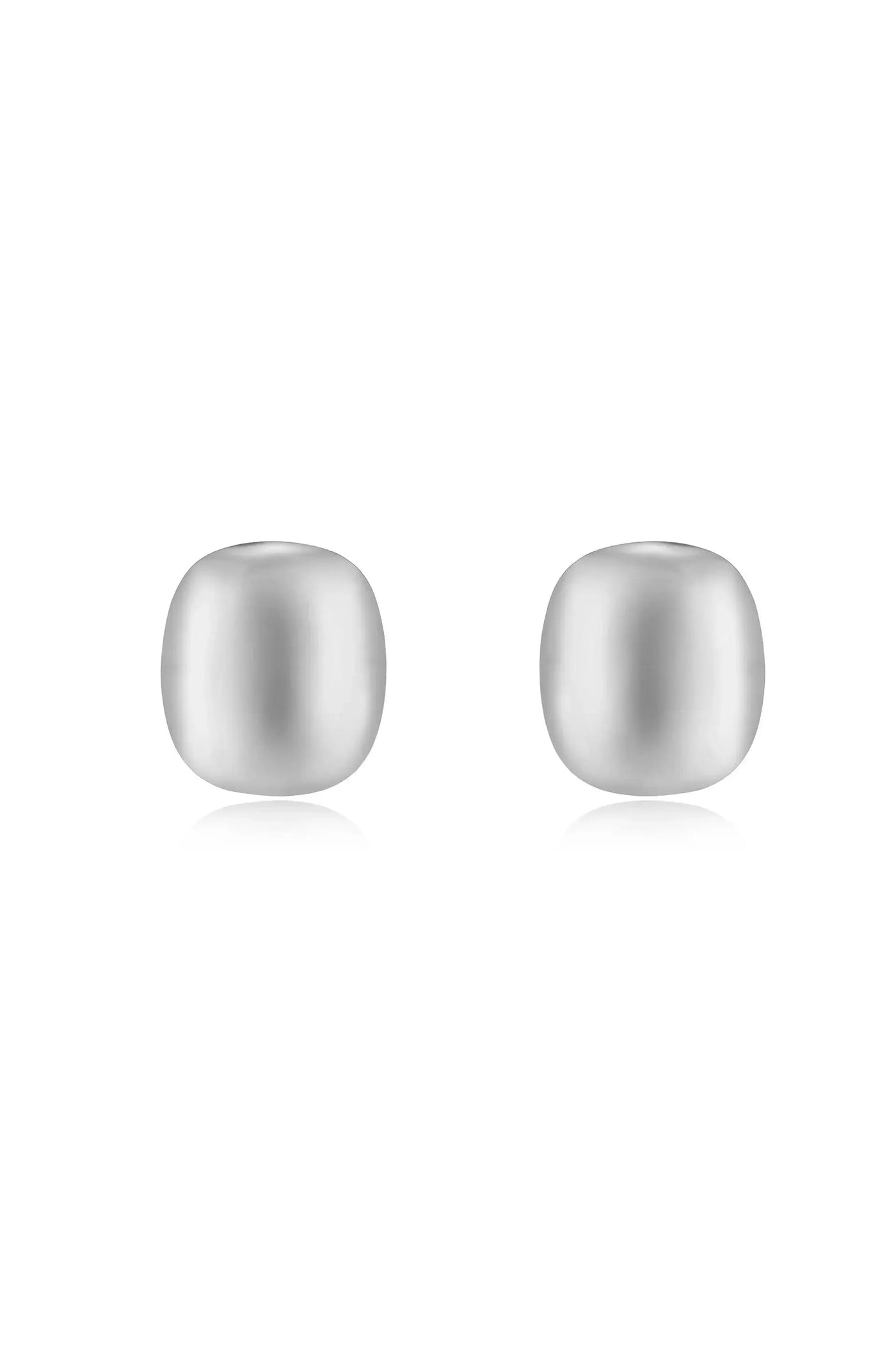 Two smooth, round silver beads are positioned side by side. They reflect light, creating a subtle shine against a plain white background.