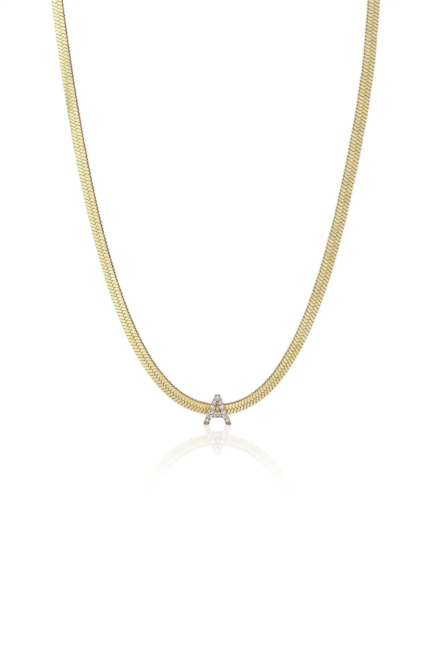 A gold chain necklace features a shimmering letter "A" embellished with diamonds, displayed against a plain white background that highlights its elegant design and reflective qualities.