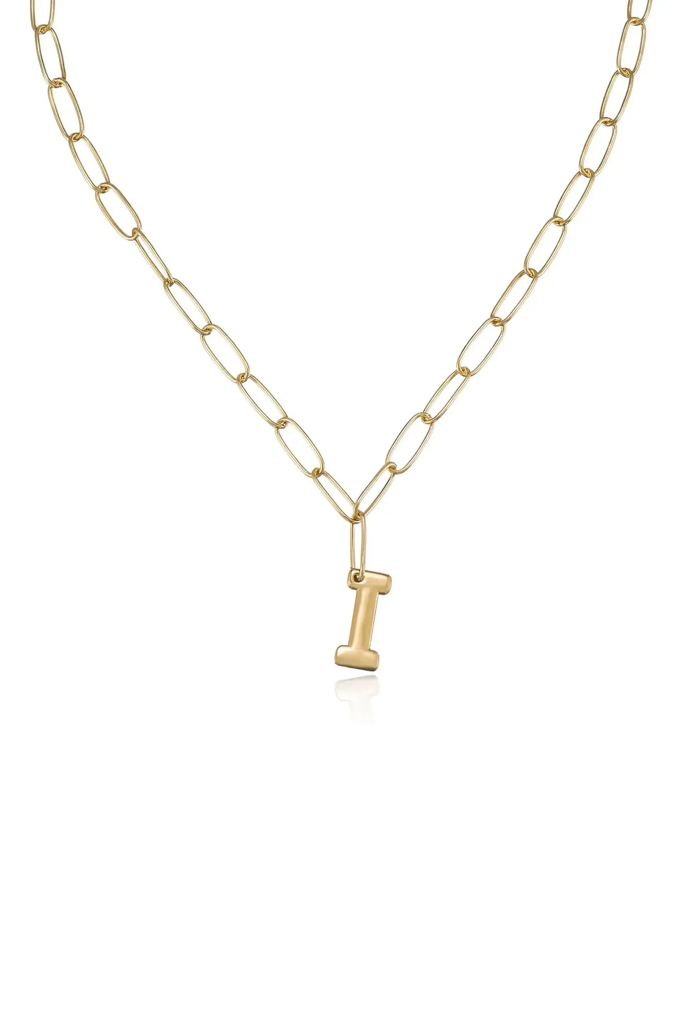 A gold chain necklace features elongated links, with a small golden pendant shaped like the letter "I" hanging at the center. The backdrop is plain and light.