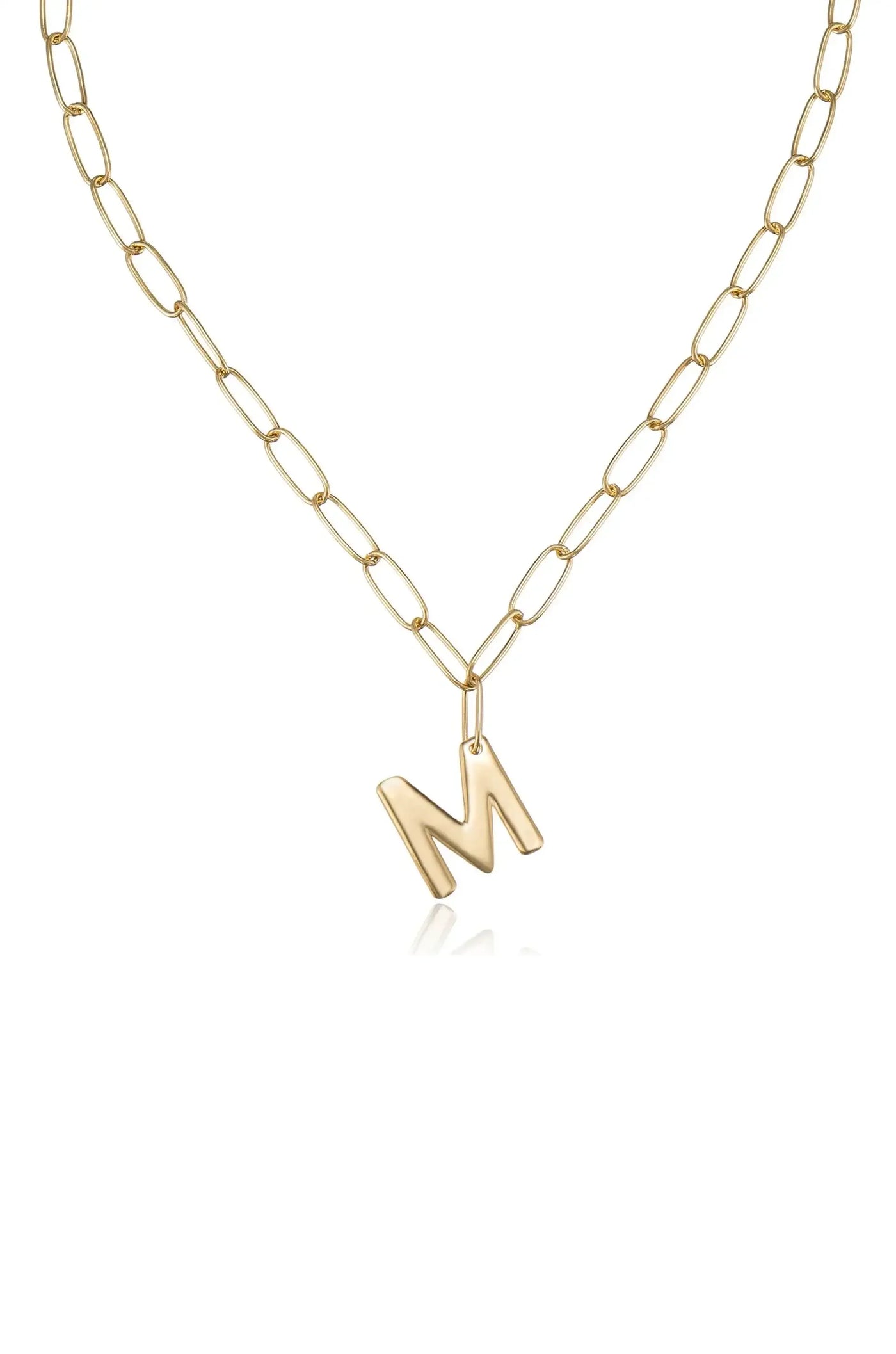A gold chain necklace features an asymmetrical letter "M" pendant hanging from it. The necklace is set against a white background, emphasizing its shiny texture and design.