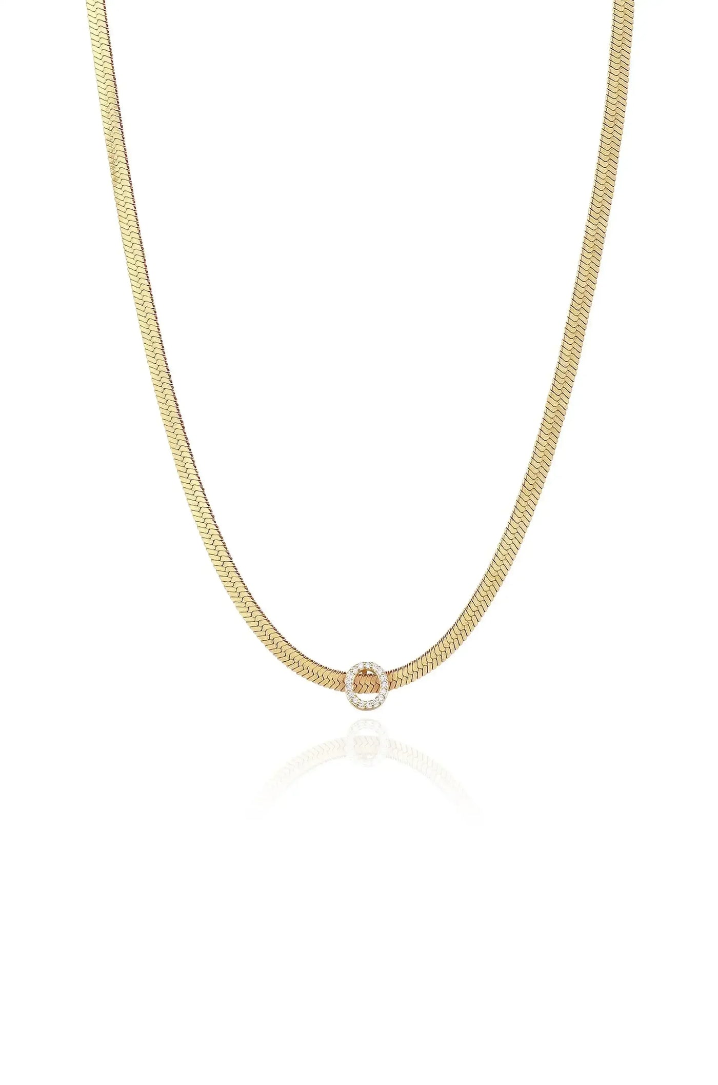 A sleek, gold-colored necklace hangs horizontally with a shiny circular clasp in the center, reflecting softly on a white background, highlighting its elegance and design.