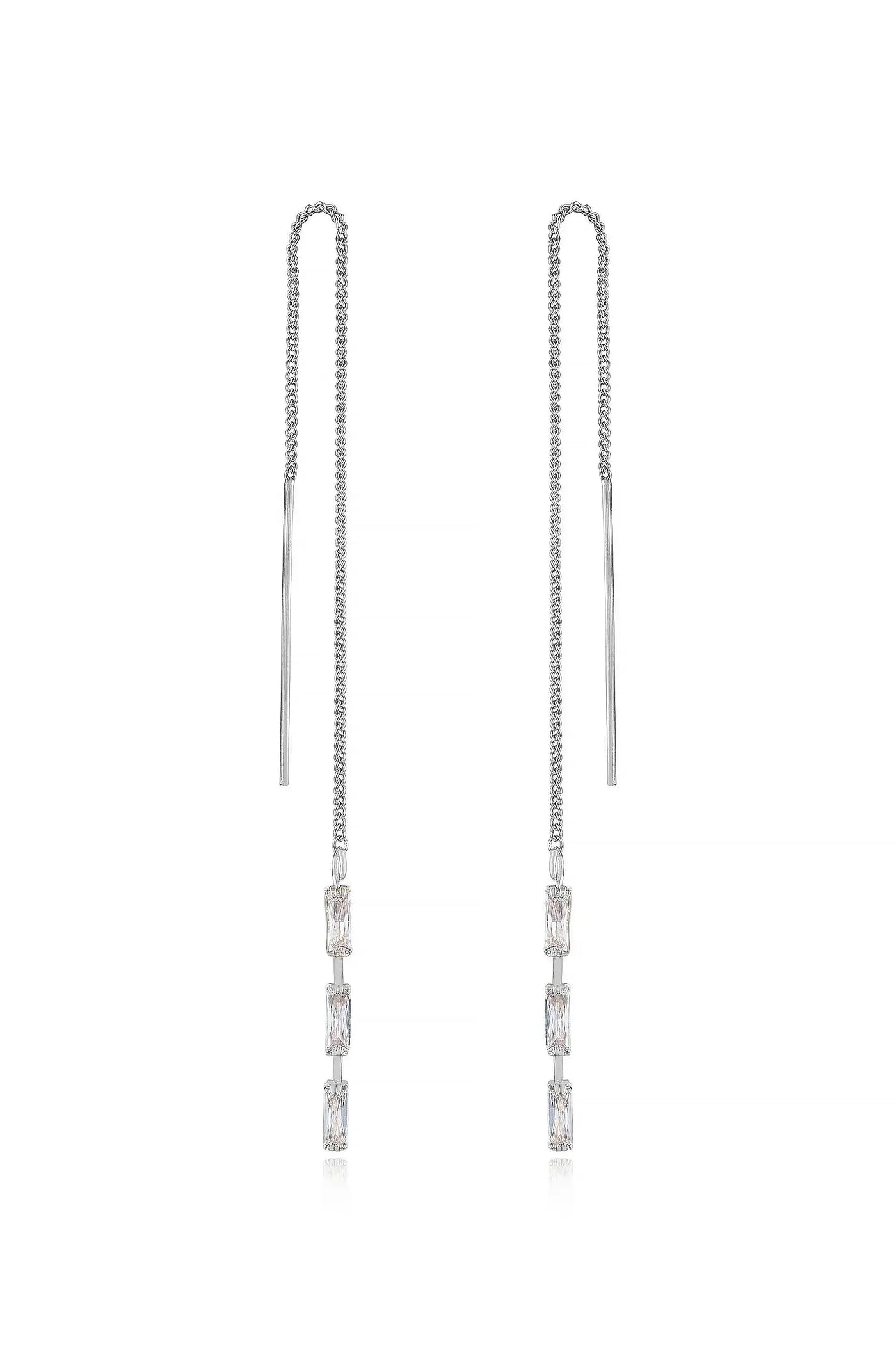 Two elegant silver chain earrings hang vertically, featuring rectangular gemstones that glisten. The background is minimalistic, enhancing the jewelry's shine and design.
