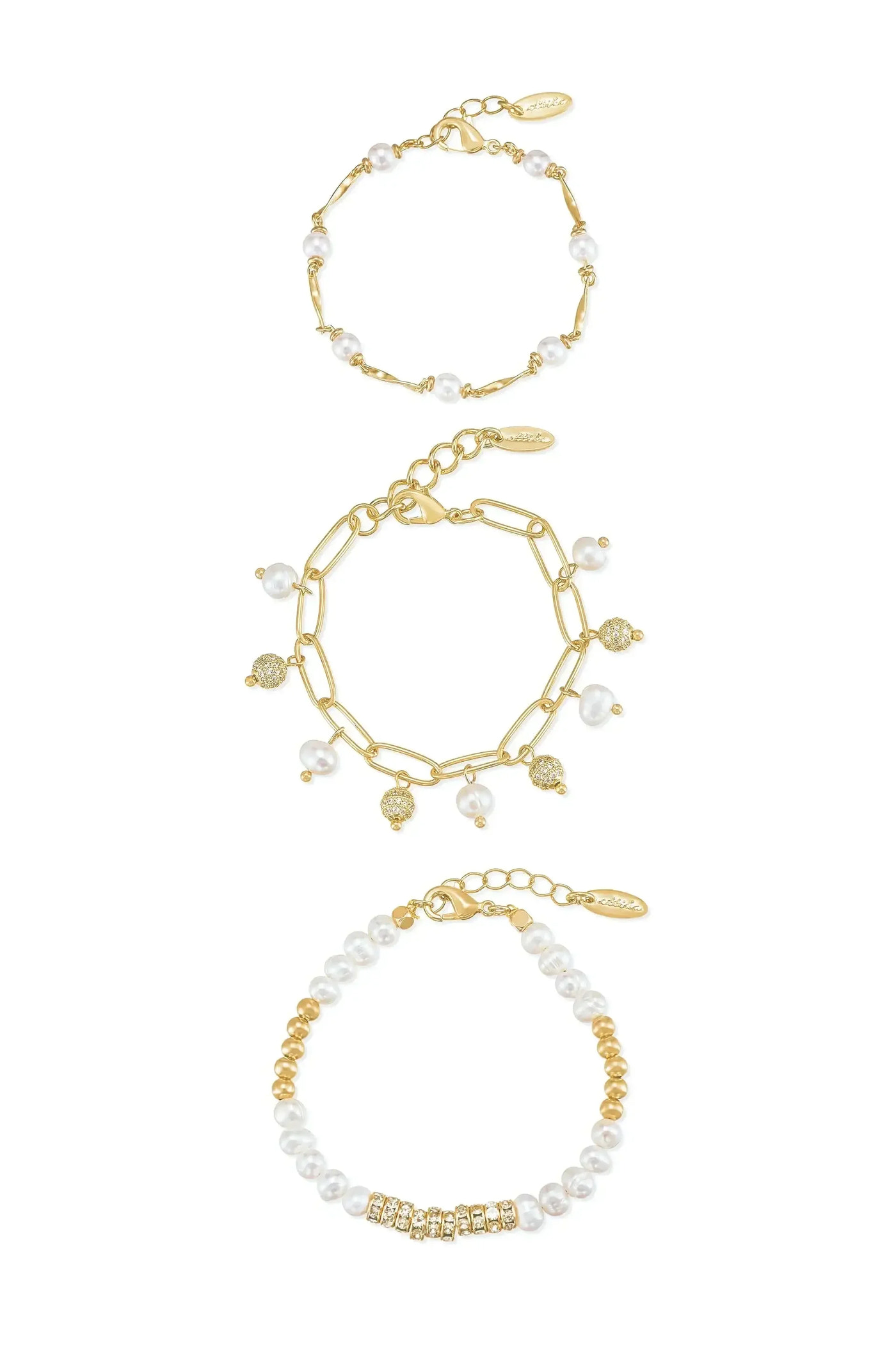 Three elegant bracelets are displayed together: one with gold links and pearls, a second featuring linked pearls with gold accents, and a third with alternating gold and pearl beads.