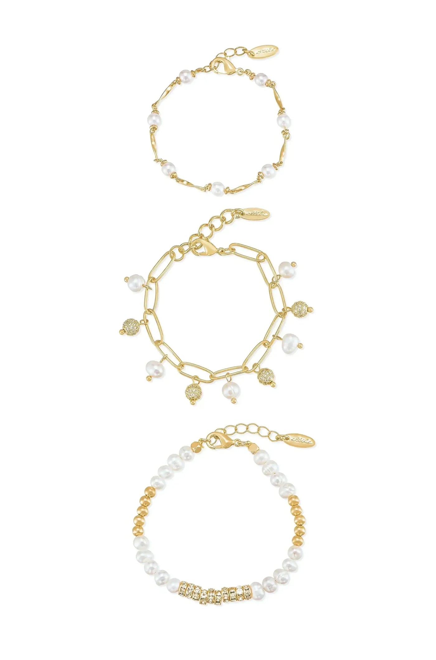 Three elegant bracelets are displayed together: one with gold links and pearls, a second featuring linked pearls with gold accents, and a third with alternating gold and pearl beads.