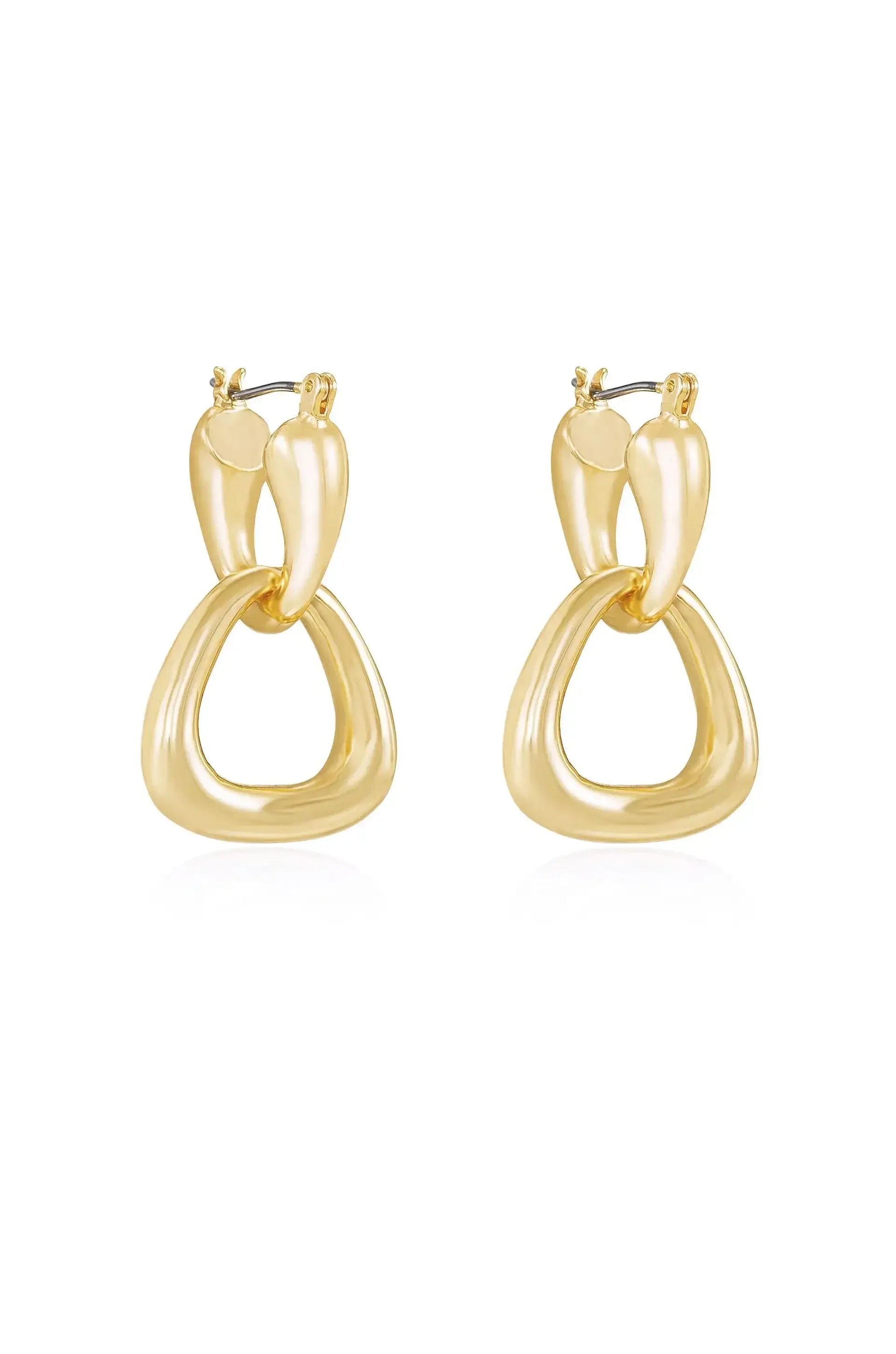 A pair of elegant gold earrings showcases a unique design, featuring interlocking shapes. They hang gracefully, reflecting light in a simple, clean setting.