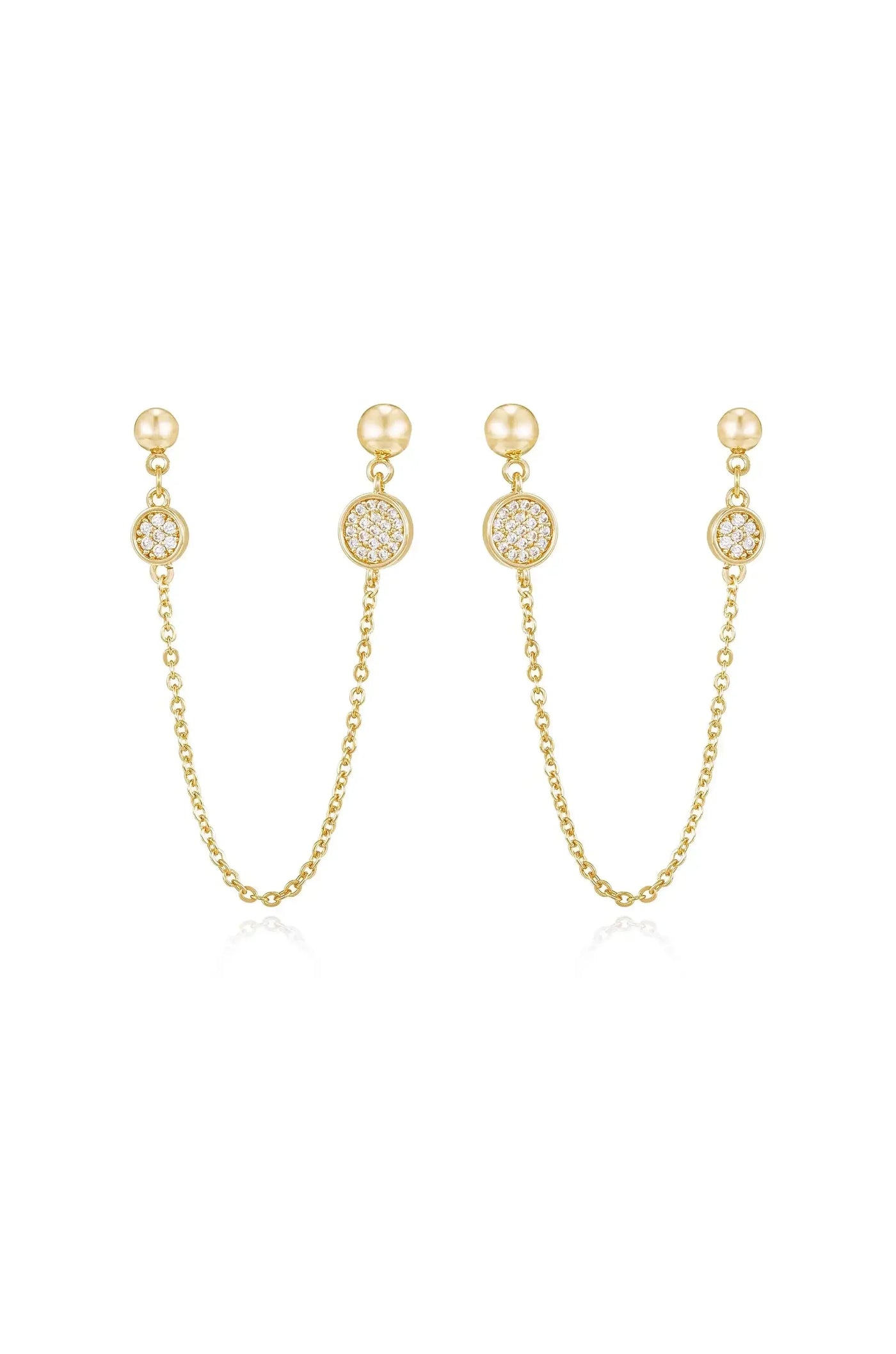 Gold earrings featuring two pendants connected by delicate chains. Each pendant has a central round design embellished with sparkling stones, reflecting light against a plain white background.