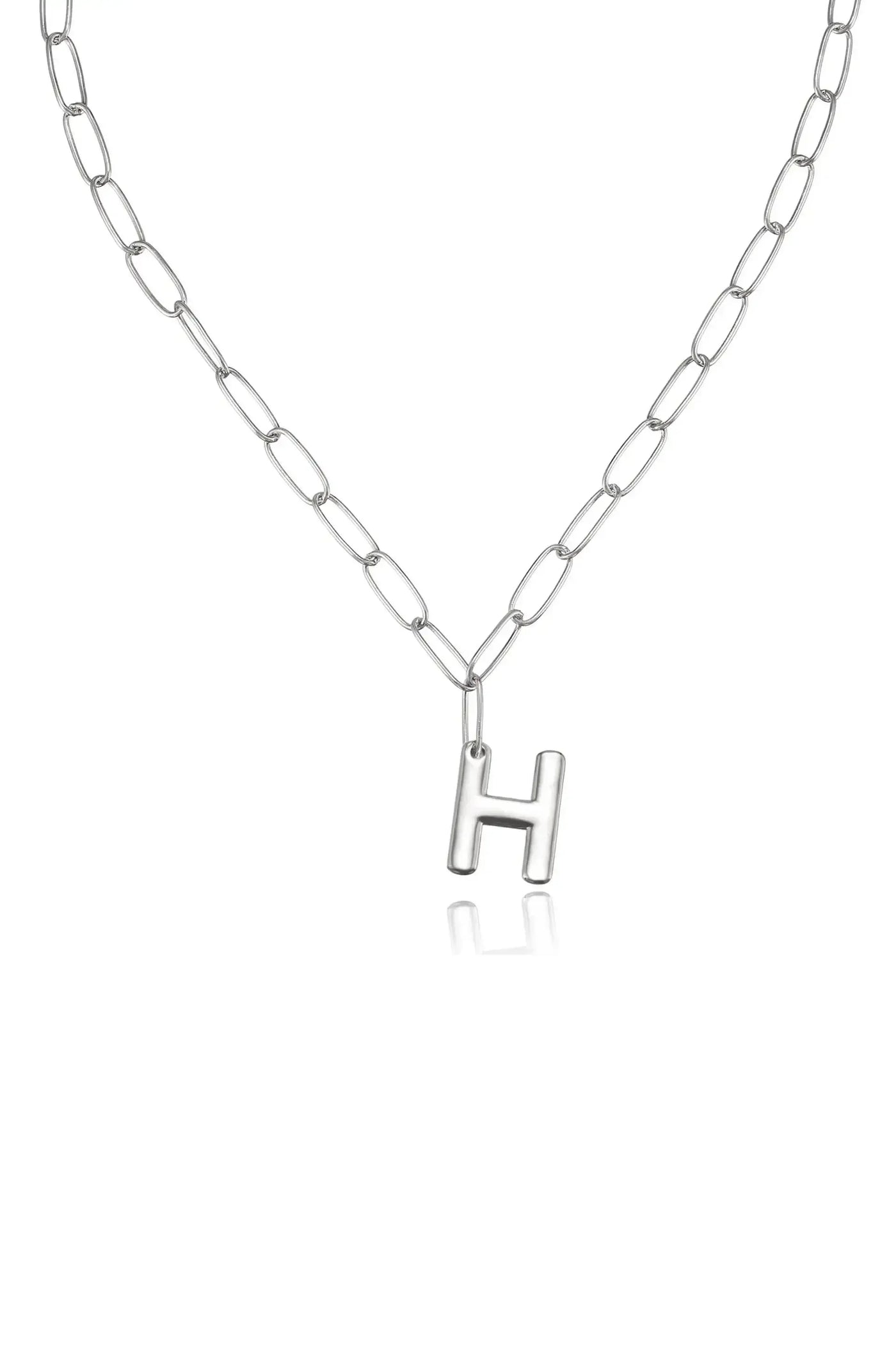 A silver chain necklace features an uppercase "H" pendant. The necklace hangs against a plain background, emphasizing its simple yet elegant design.