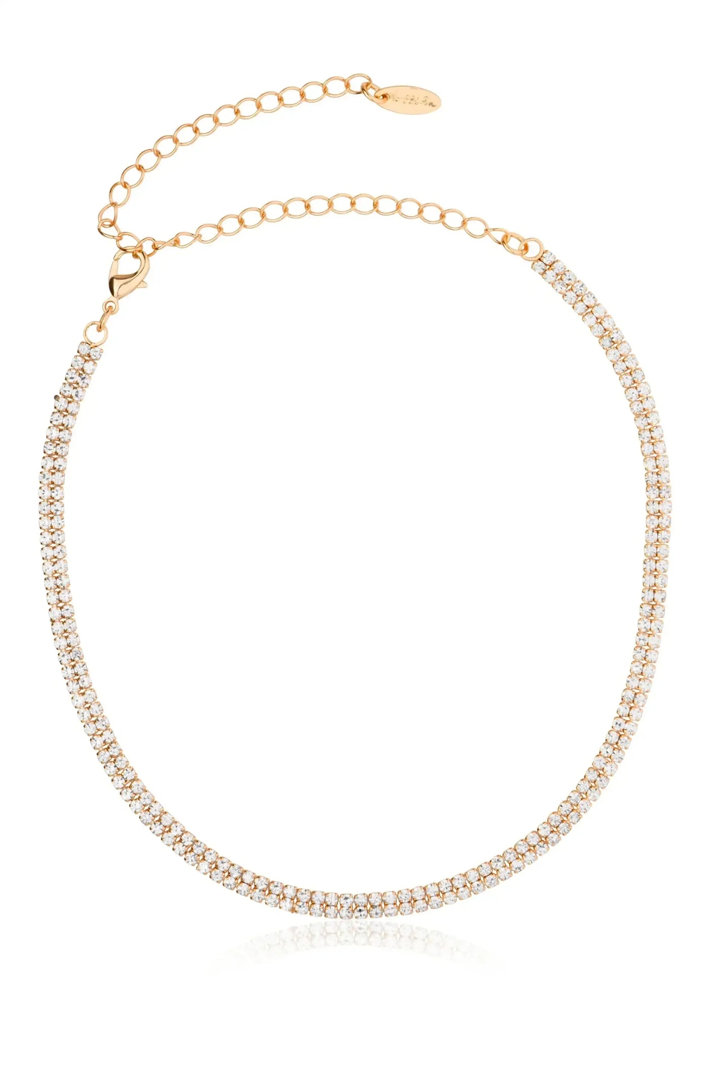 A gold necklace adorned with sparkling rhinestones is positioned floating against a plain white background. It features a clasp and chain for adjustment, reflecting light elegantly.