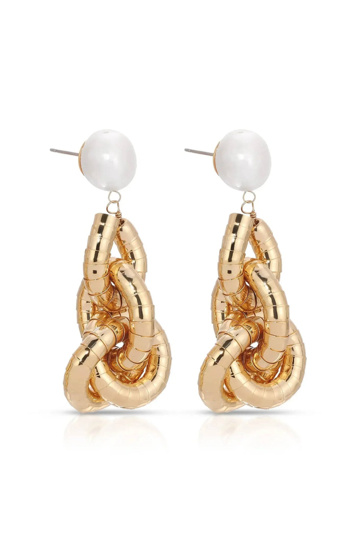 Gold hoop earrings intertwined in a decorative chain design hang from a small pearl stud. They are displayed against a white background, creating a clean and elegant presentation.