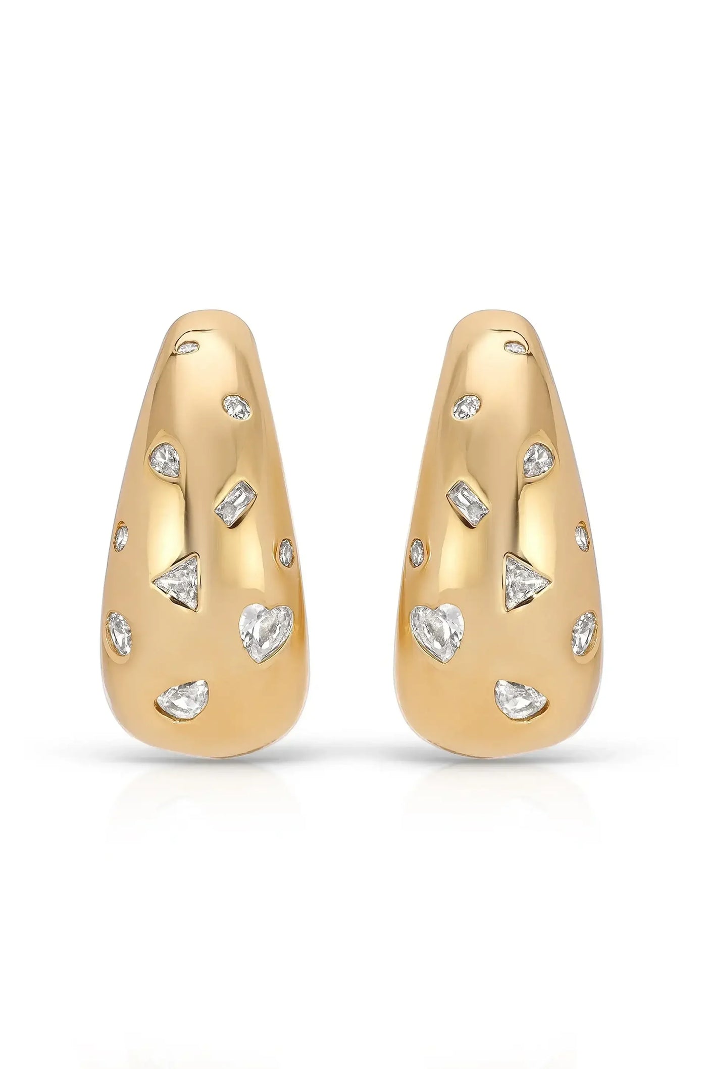 Two gold-tone earrings are displayed, featuring a smooth surface adorned with variously shaped, sparkling gemstones. They rest against a clean, white background, showcasing their elegant design.