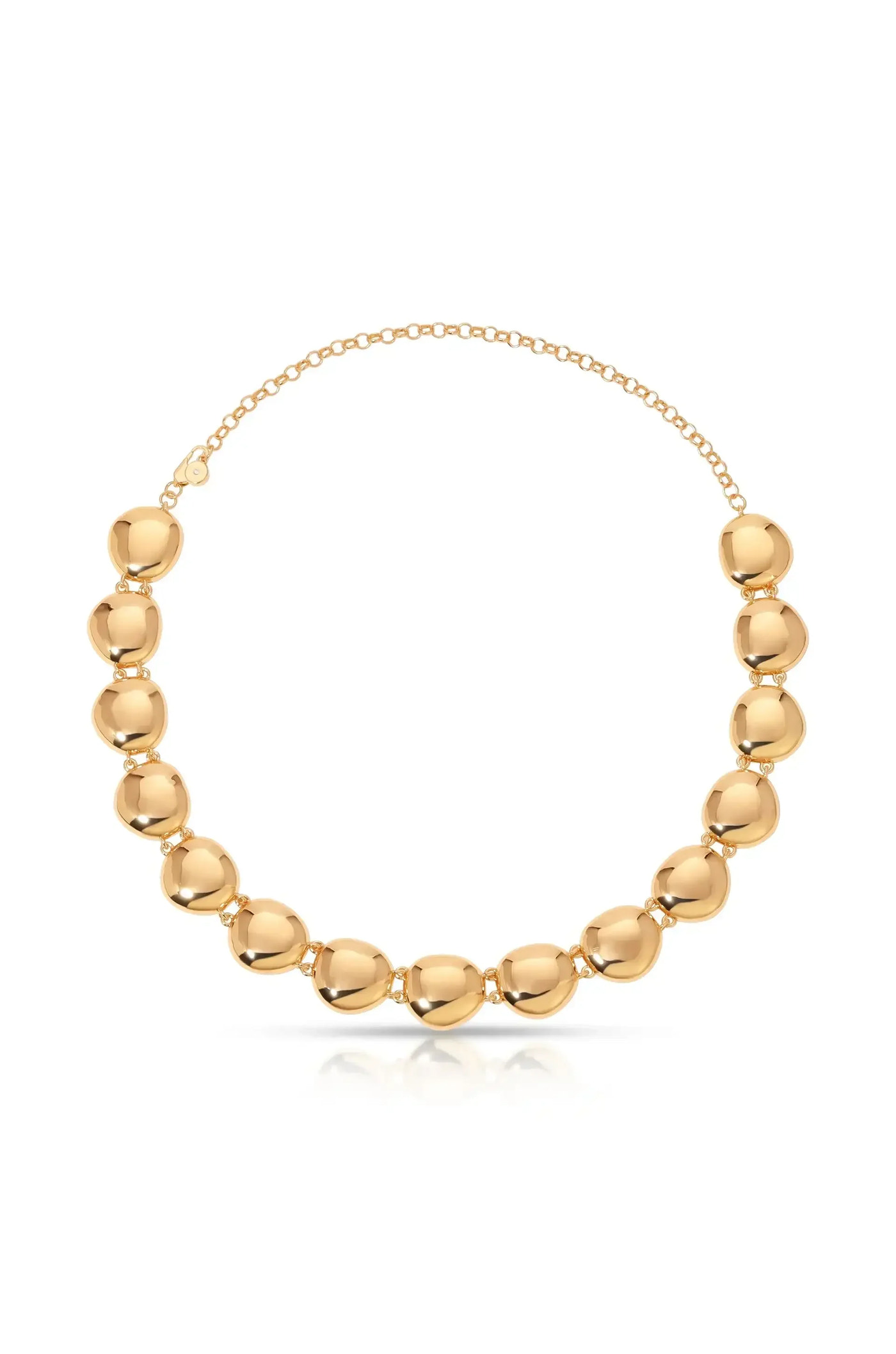 A polished golden necklace features a series of smooth, rounded beads joined by links. It rests on a reflective surface, highlighting its shiny texture and elegant design.