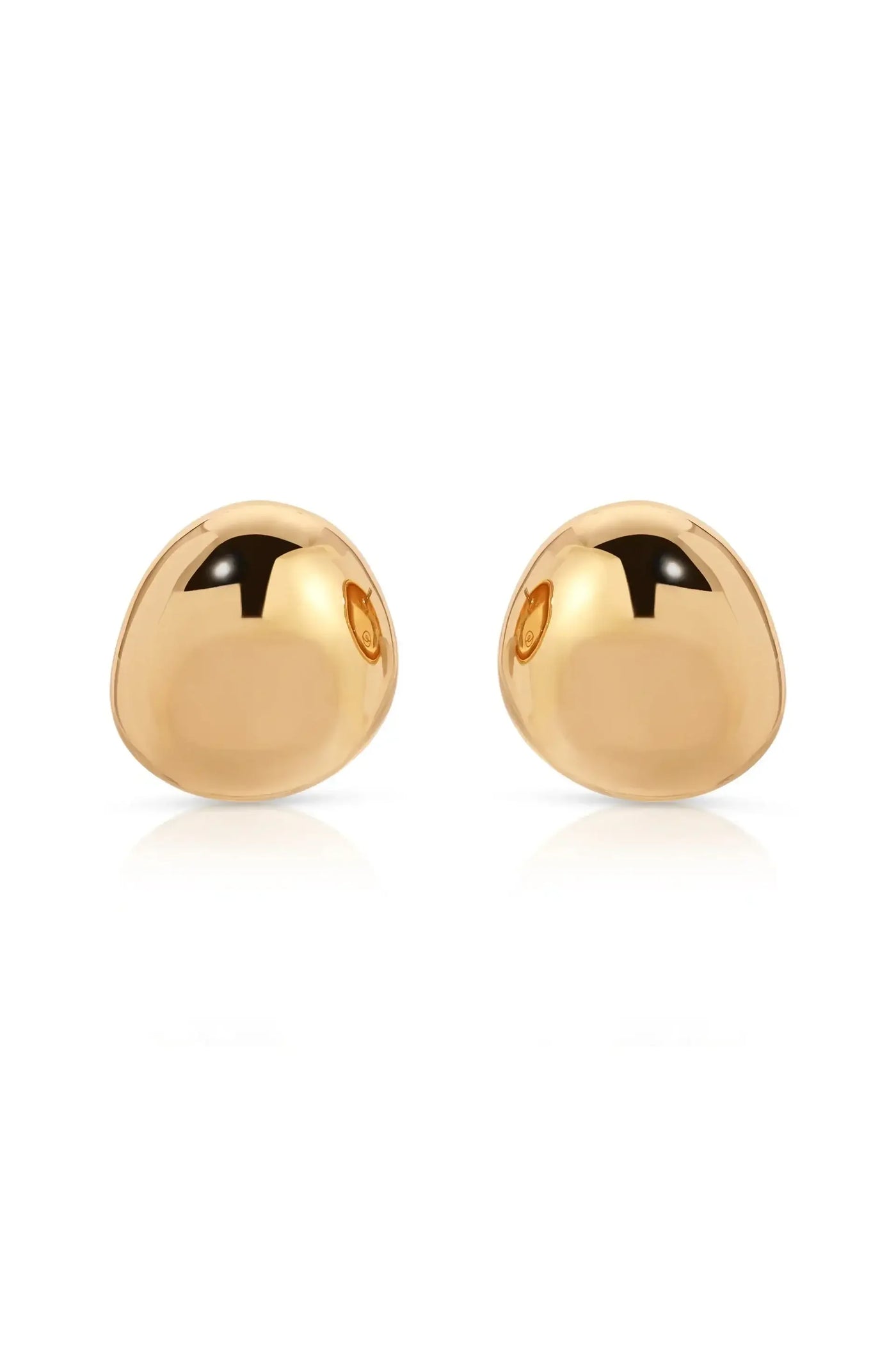 Two polished gold dome-shaped earrings are positioned symmetrically, reflecting light and casting soft shadows on a white background, creating an elegant and minimalist presentation.