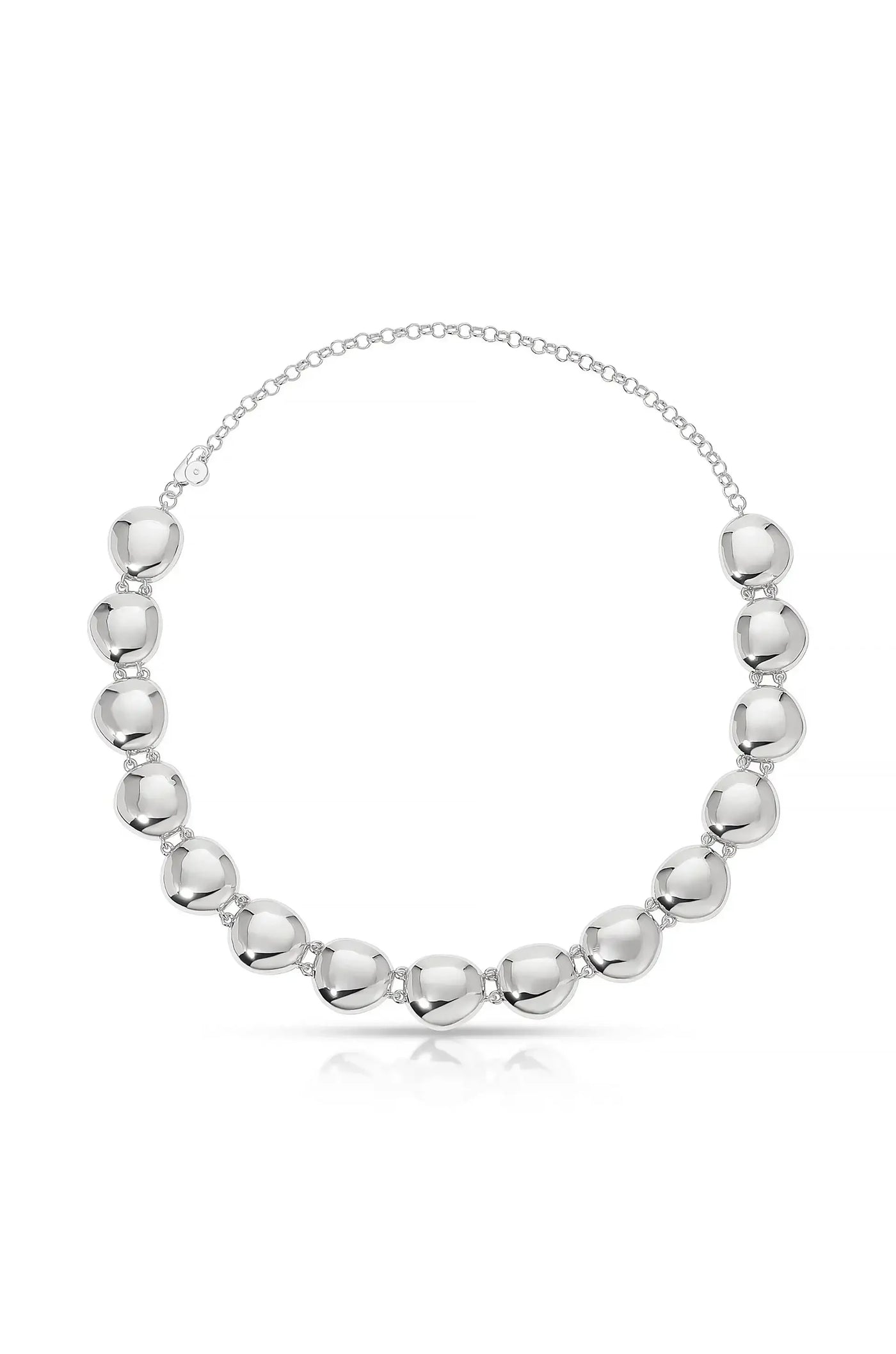 A silver necklace features a series of shiny, rounded links, elegantly connected by small chains. It rests against a plain, light background, highlighting its reflective surfaces and design.