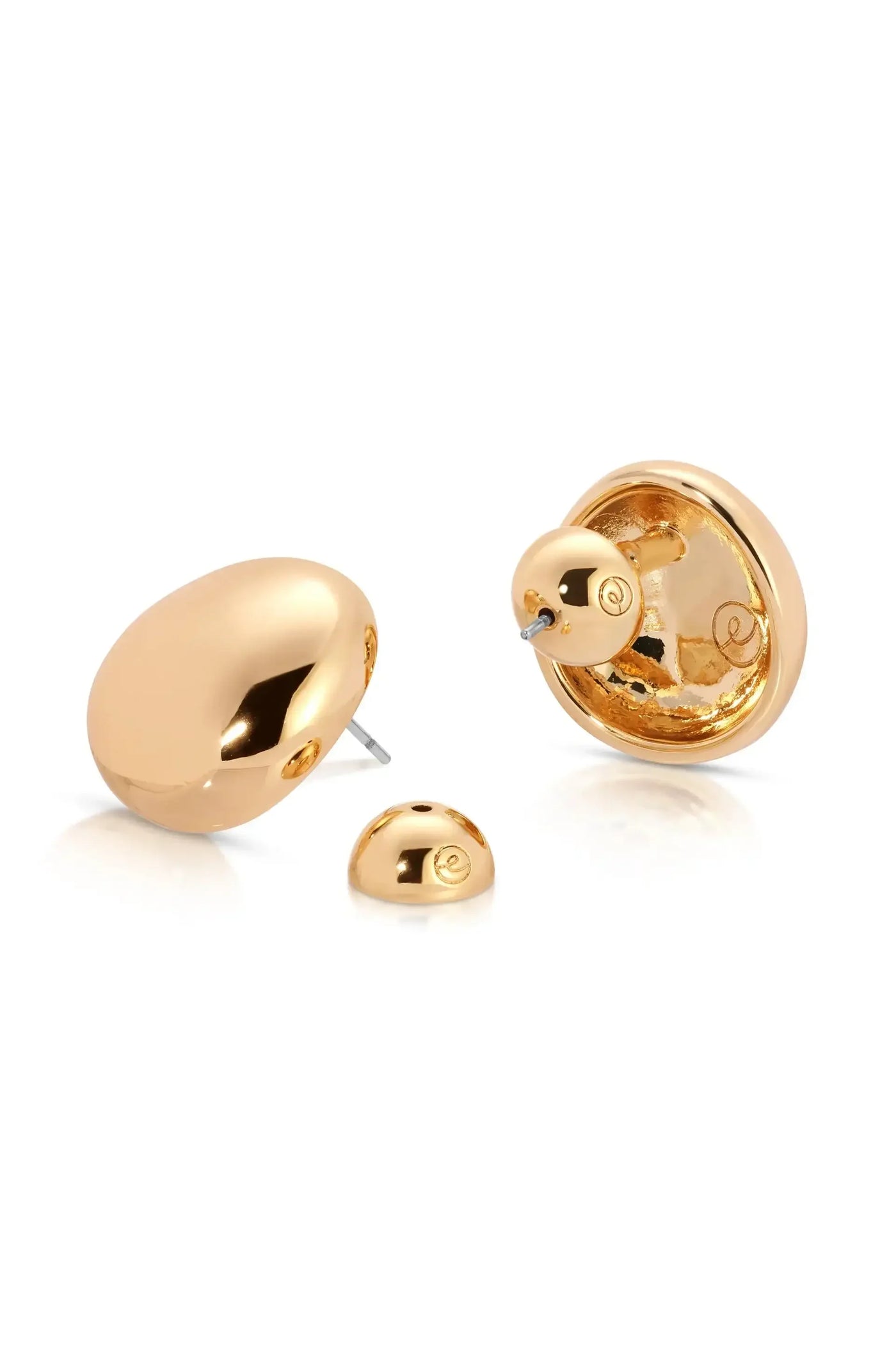 A pair of gold earrings is displayed. One earring is larger and rounded, while the other is a smaller spherical piece, showcasing a shiny, reflective surface.