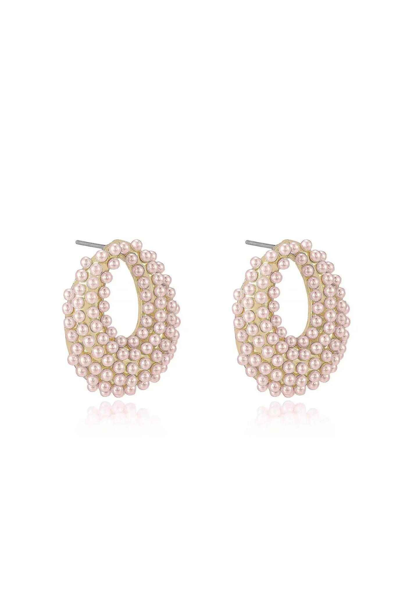 Pearl earrings are displayed, showcasing a large oval shape adorned with numerous small pink pearls. The setting appears to be metallic, creating a reflective background that enhances the jewelry's elegance.