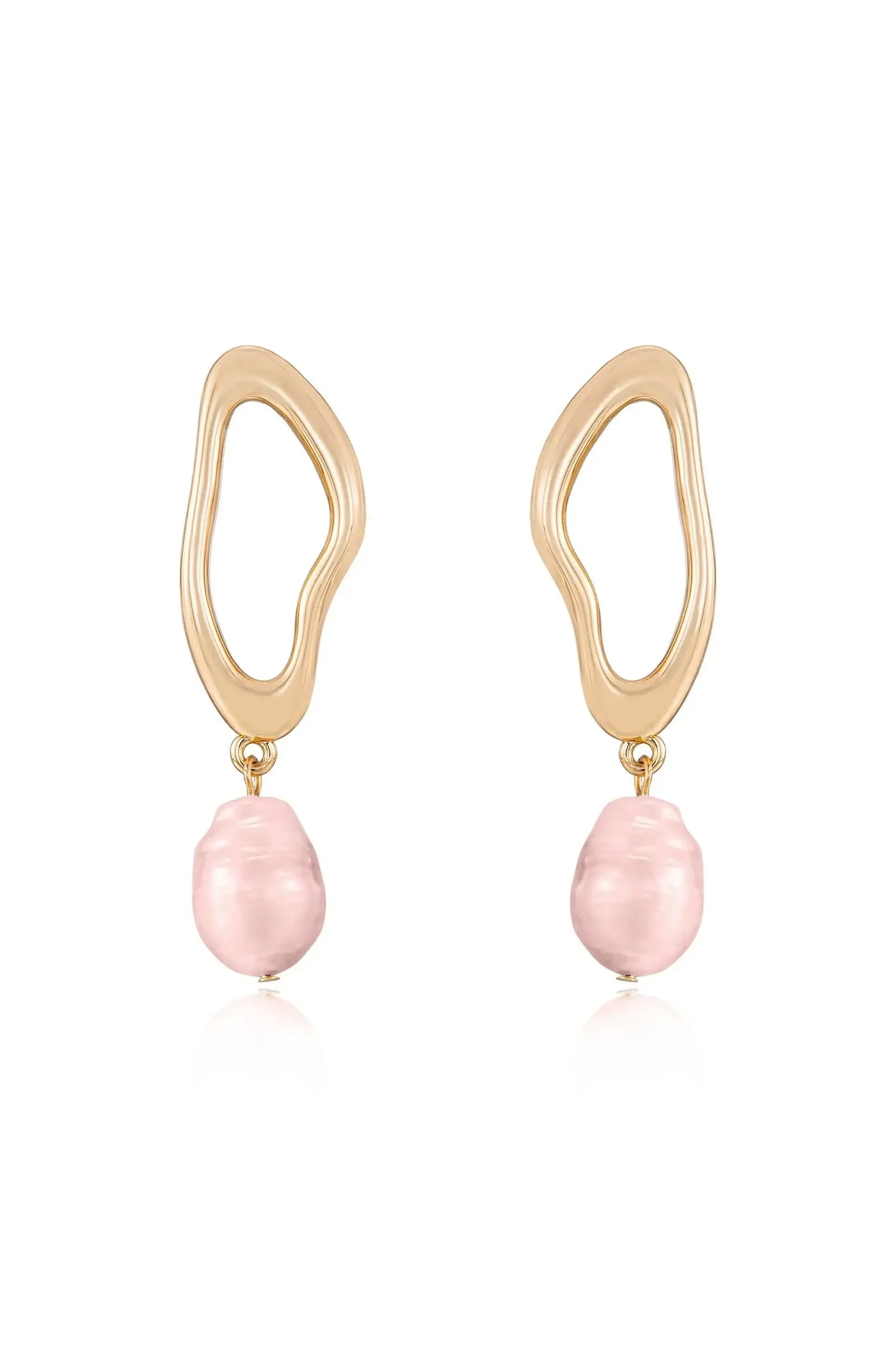 Gold earrings feature a wavy, abstract design holding a pink, irregular-shaped pearl. The earrings hang vertically, showcasing their unique style against a simple, light background.