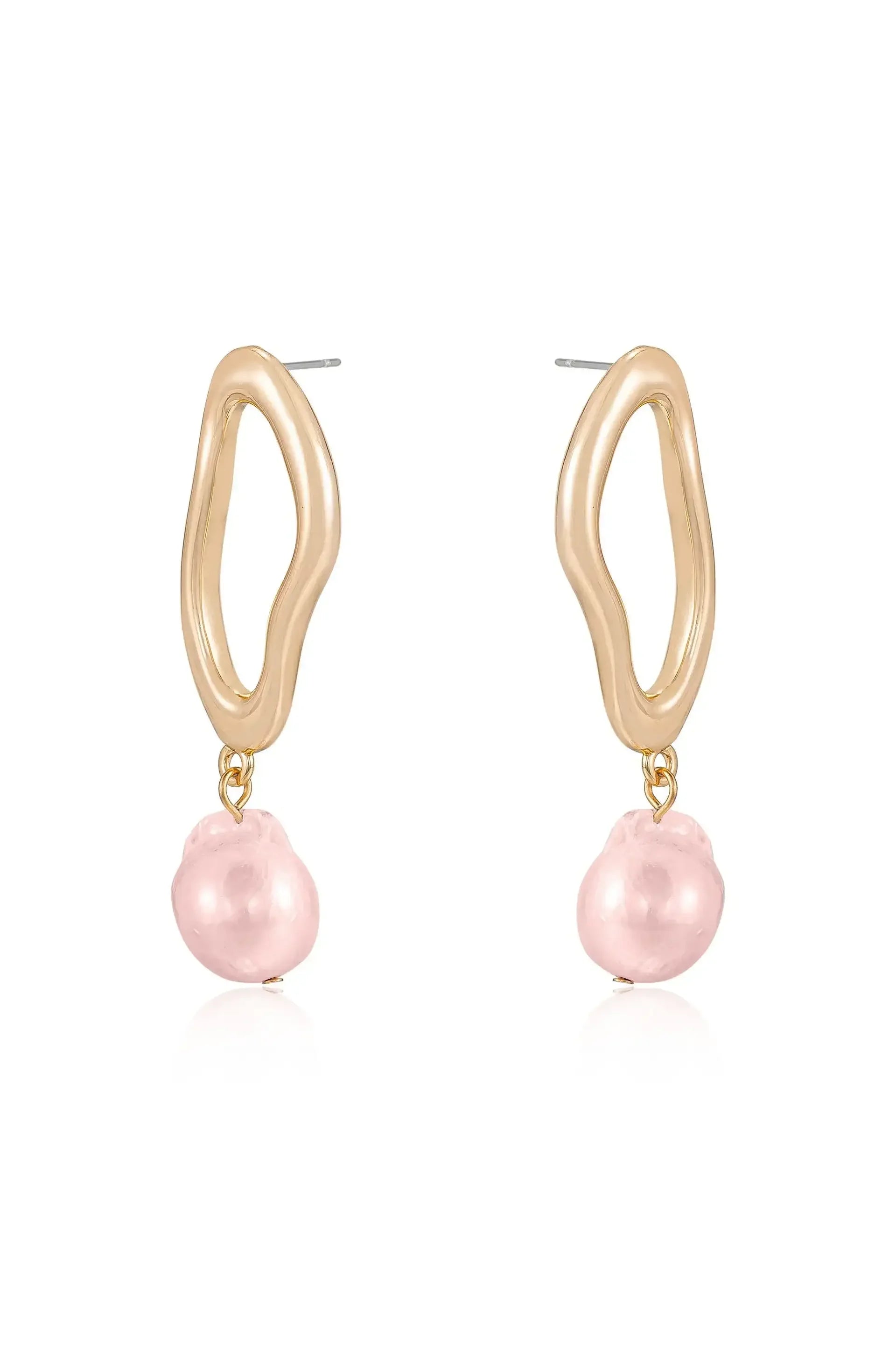 Gold-tone earrings feature an abstract, wavy shape attached to a pink pearl. They are displayed on a white background, emphasizing their shine and delicate design.