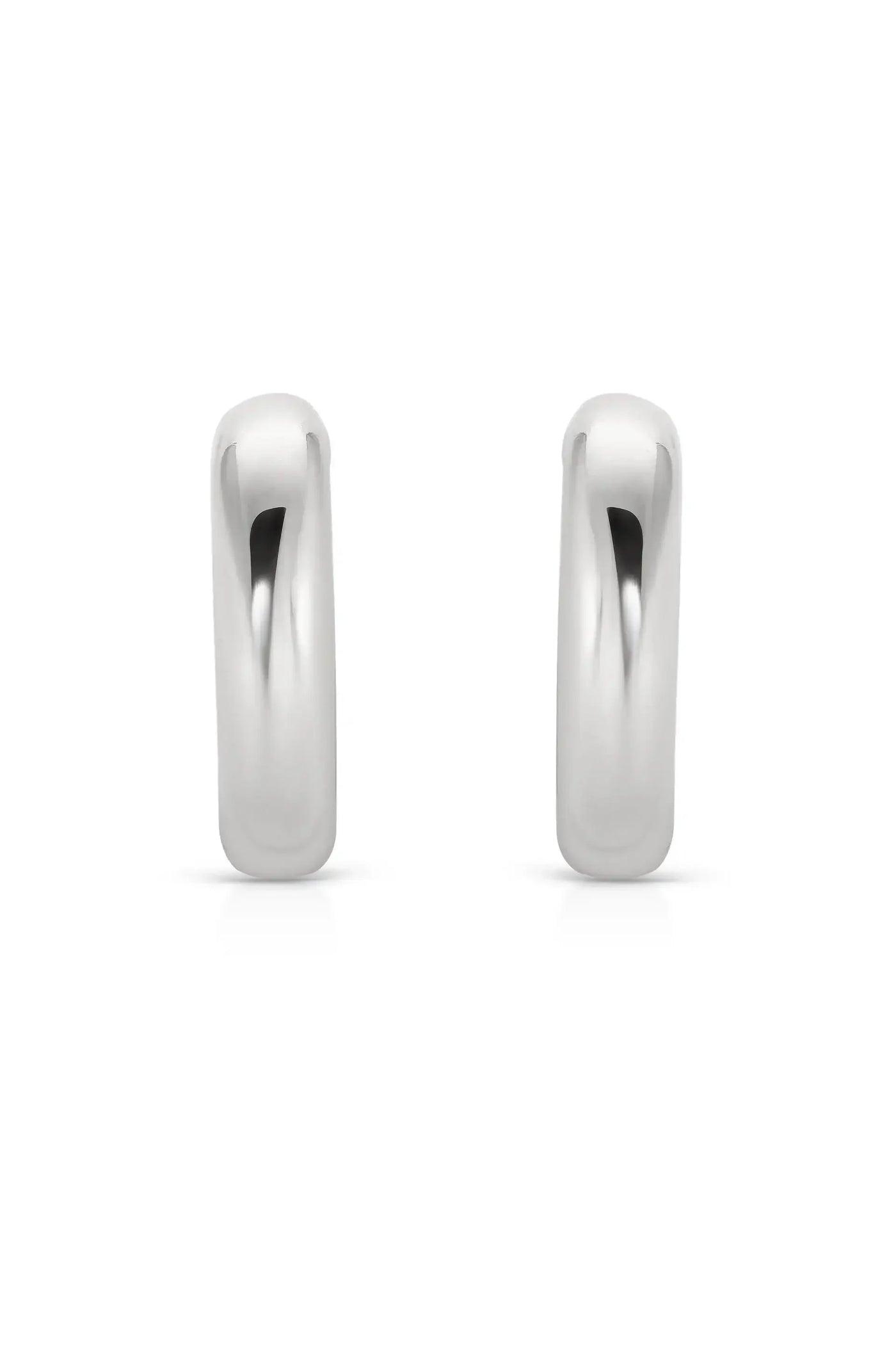 Two shiny silver hoop earrings are positioned upright, showcasing their smooth and rounded design. They are displayed against a plain white background, emphasizing their reflective surface and elegant shape.