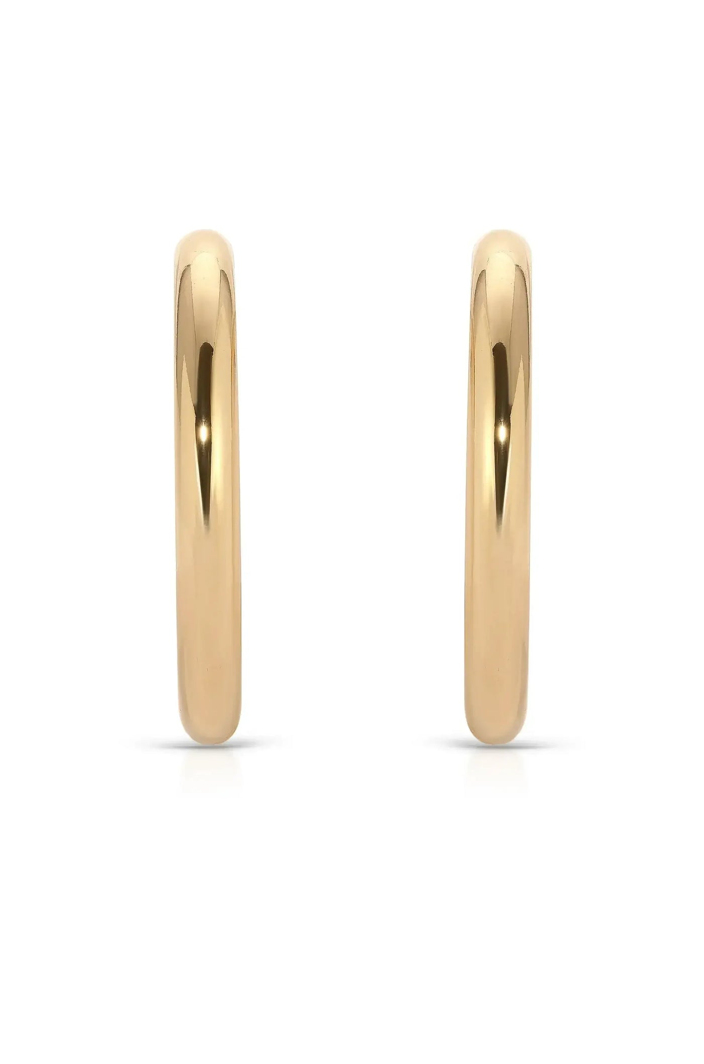 Two shiny gold hoop earrings are displayed, standing upright against a white background, highlighting their smooth surface and reflective qualities, emphasizing elegance and simplicity in design.