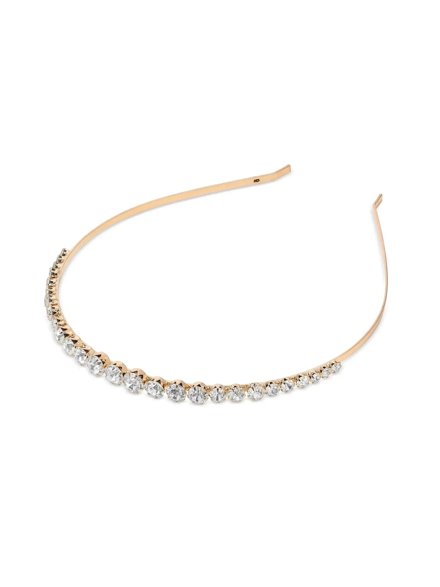 A gold-tone headband adorned with sparkling clear stones lays flat on a white background, showcasing its elegant design and shimmer, suitable for formal or fashionable occasions.