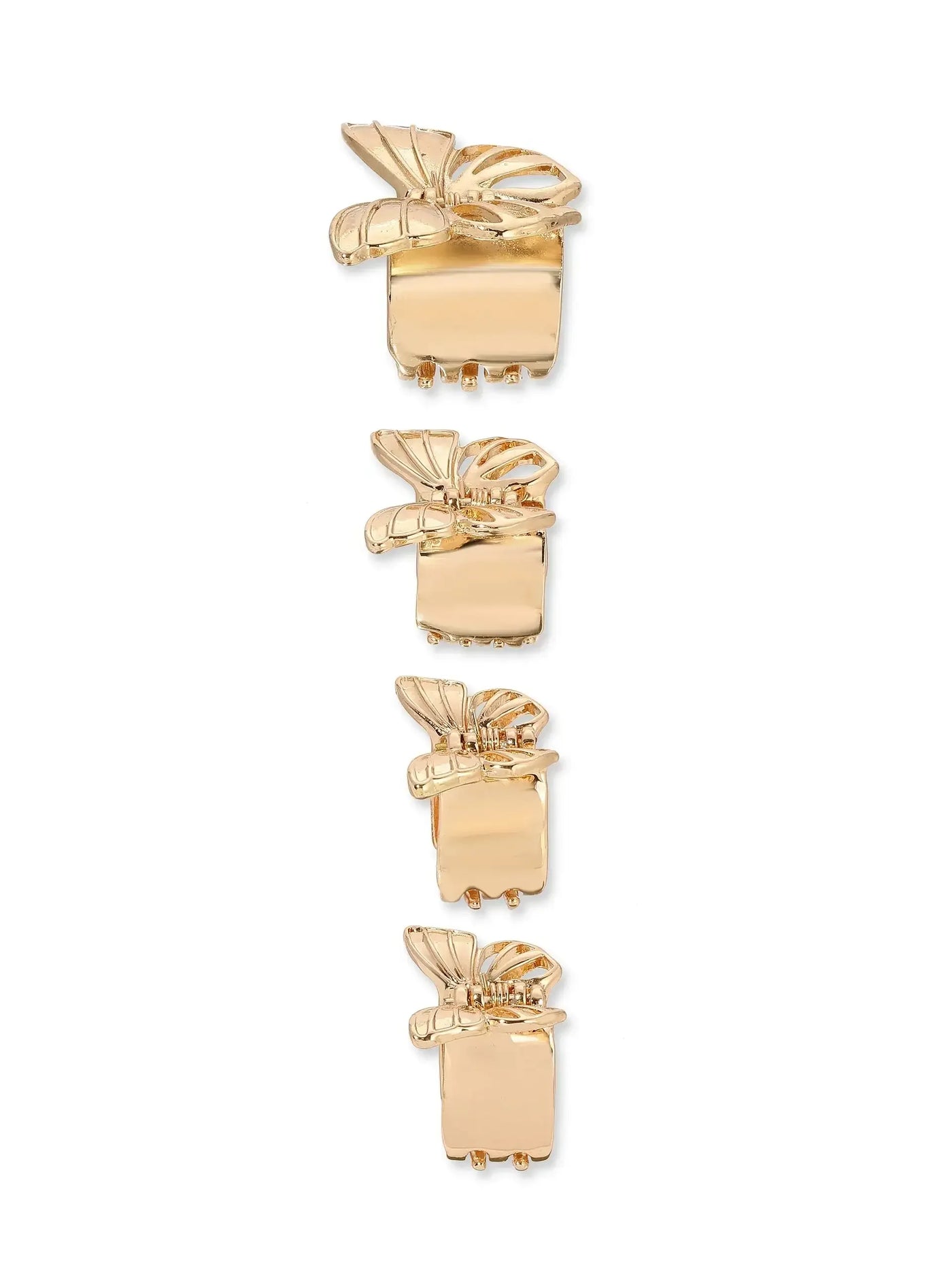Four golden hair clips are arranged vertically. Each clip features a decorative bow design at the top. The clips sit against a plain white background, emphasizing their shine and intricate details.