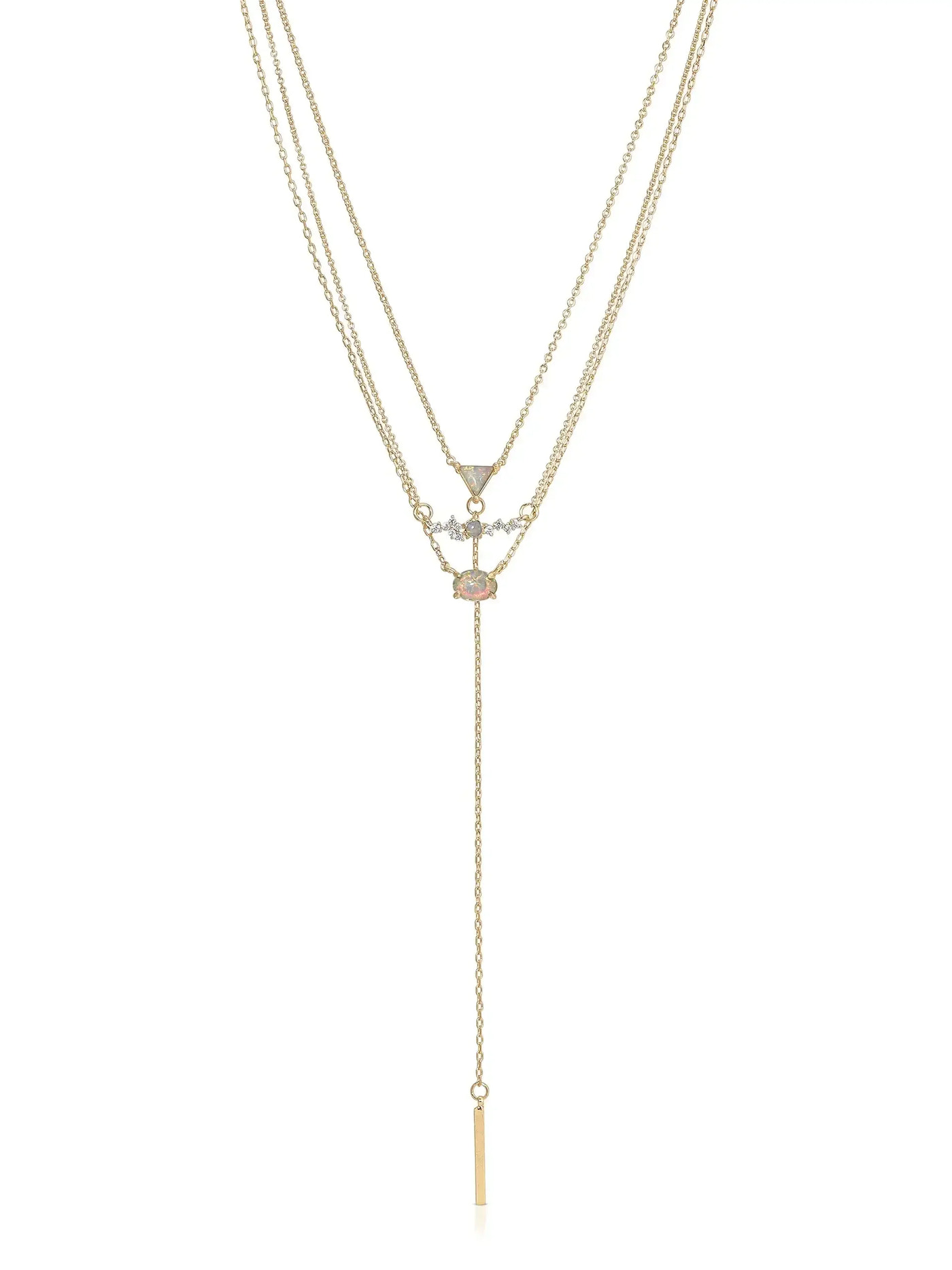 A gold layered necklace featuring three chains. The center displays an opal and diamond pendant. A vertical bar pendant hangs down, adding elegance to the piece in a simple, bright context.