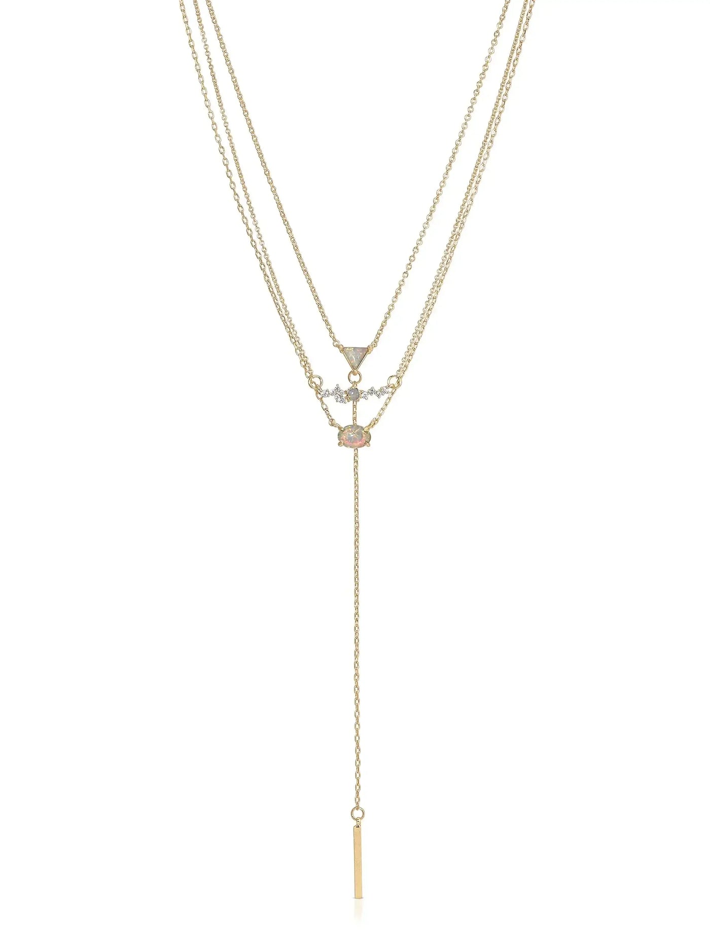 A gold layered necklace featuring three chains. The center displays an opal and diamond pendant. A vertical bar pendant hangs down, adding elegance to the piece in a simple, bright context.