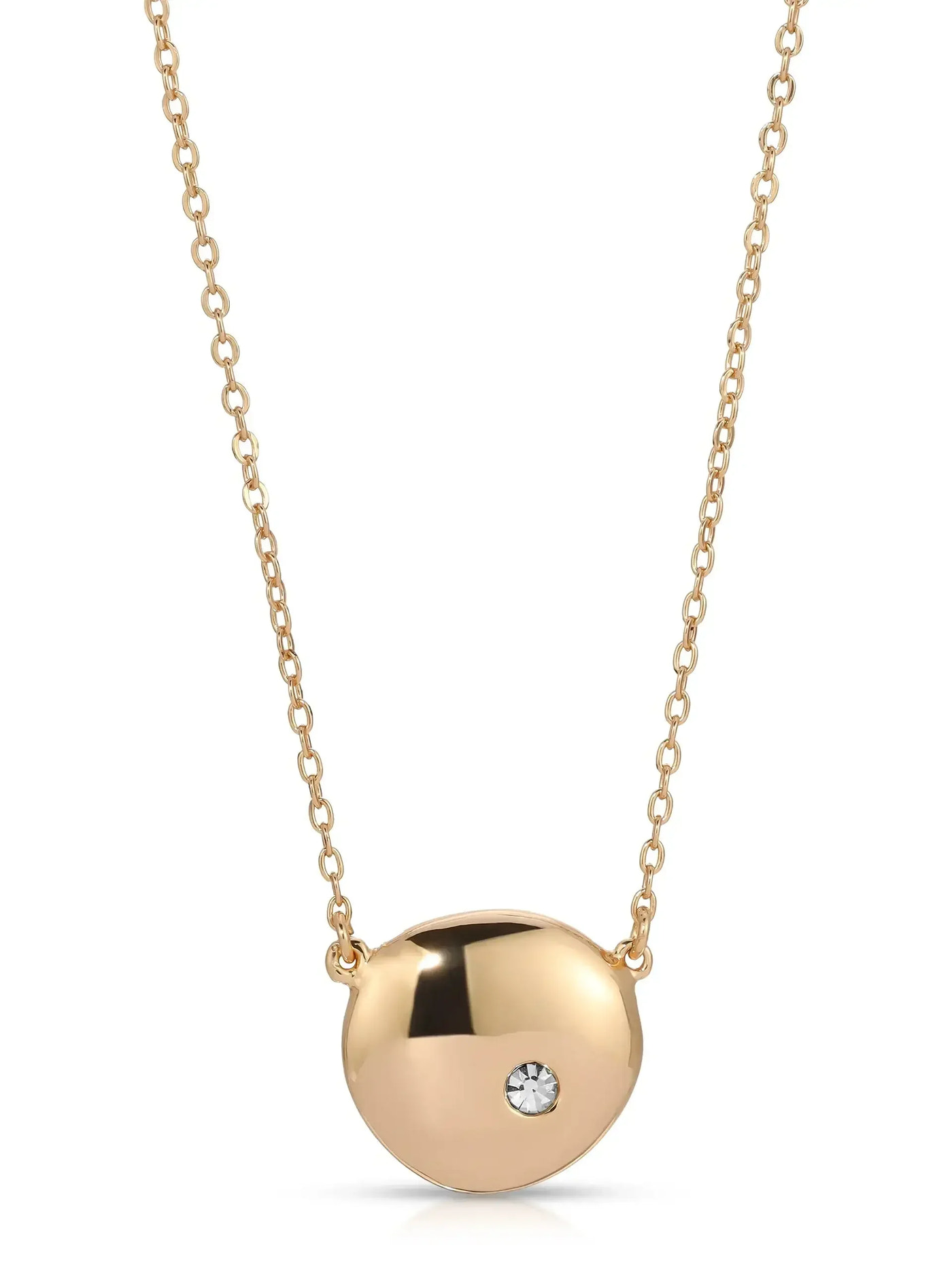 A gold necklace features a smooth, rounded pendant with a small, sparkling stone embedded. It hangs from a delicate chain, emphasizing elegance in a simple, minimalistic design.