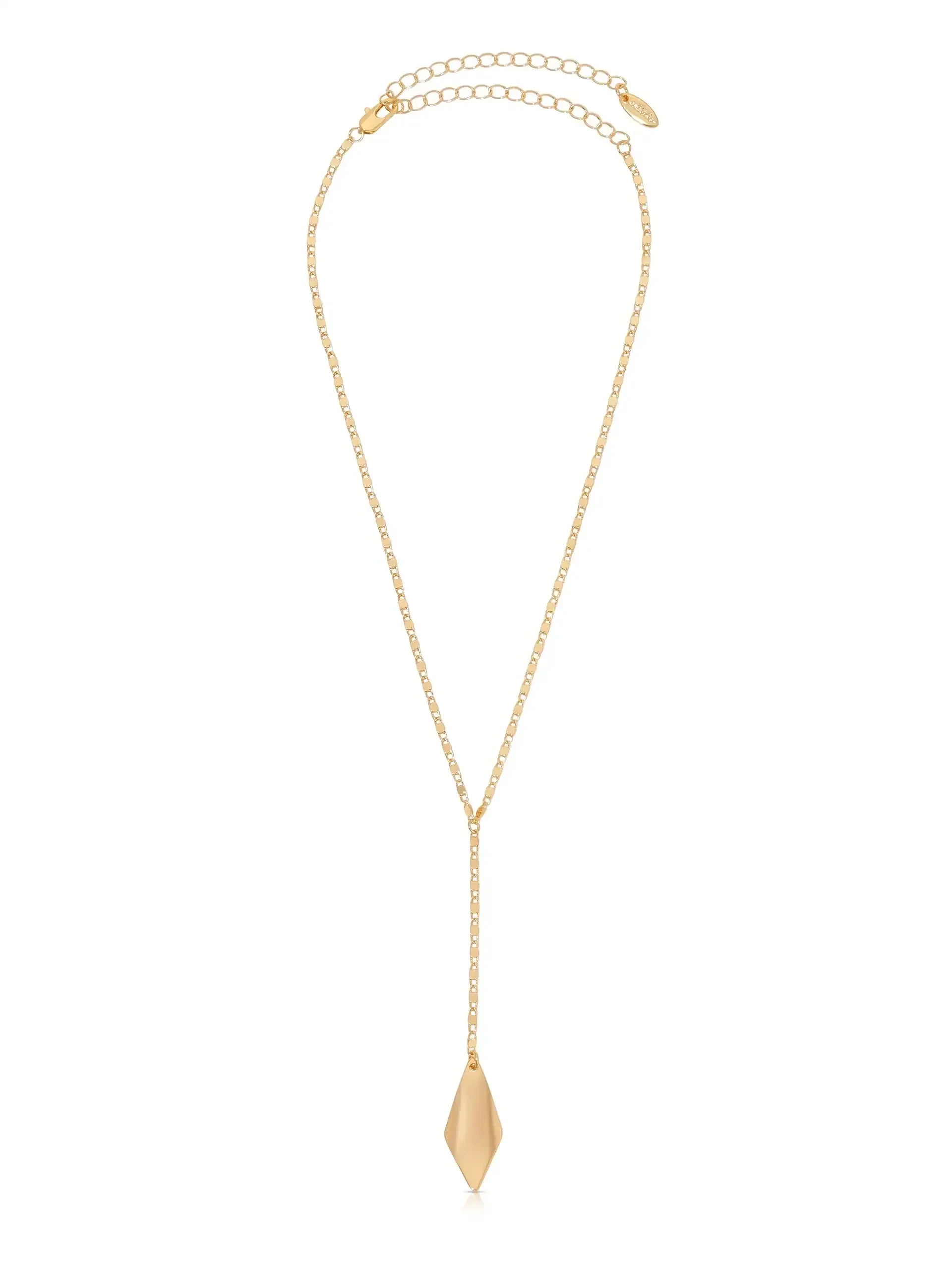 A gold necklace features a delicate chain with a pendant that has a geometric, elongated shape, hanging in the center. The background is plain white, emphasizing the jewelry.