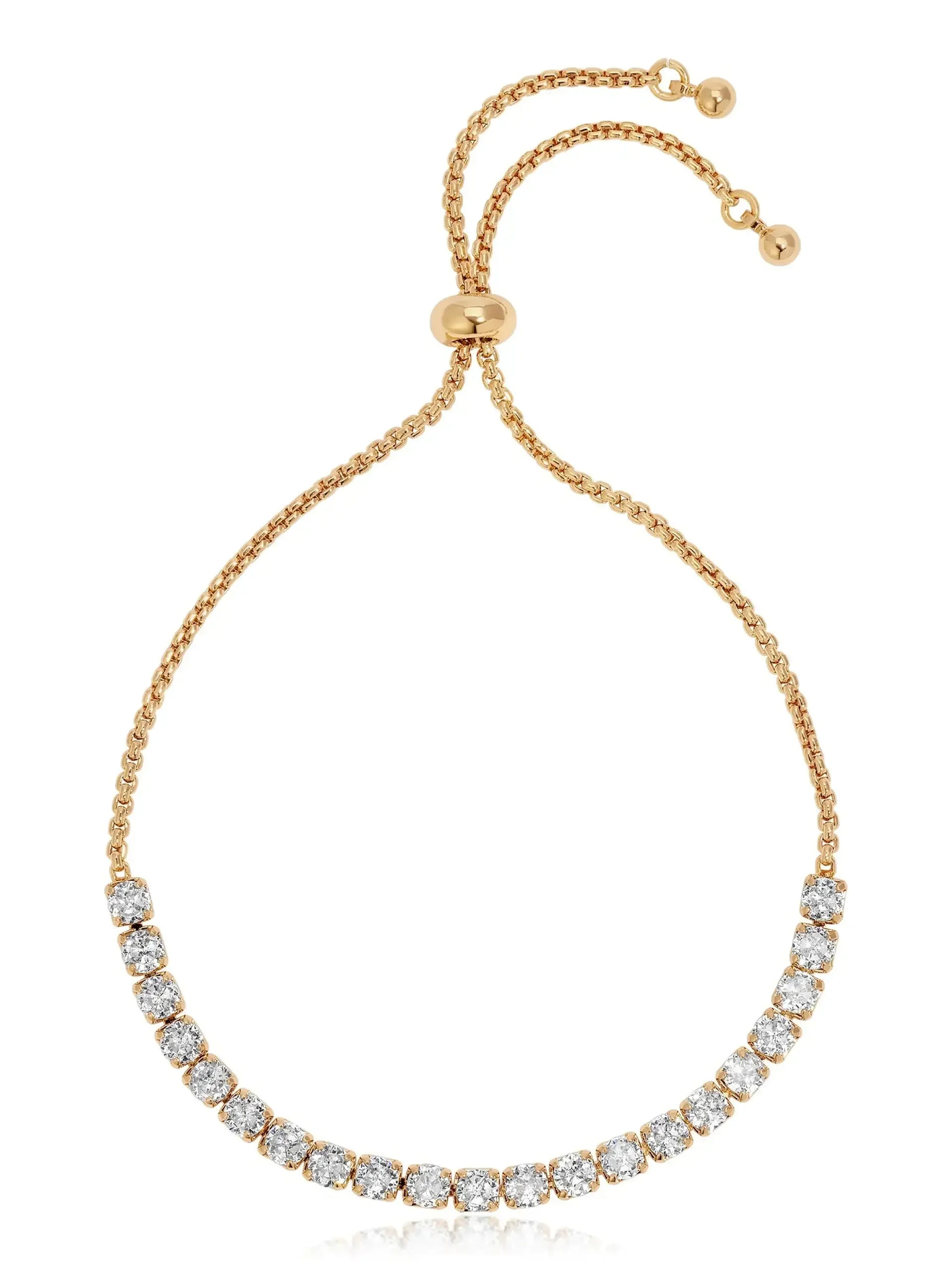 A delicate gold bracelet features a series of sparkling, round stones elegantly linked in a row. It has an adjustable chain with a sliding clasp for a secure fit.