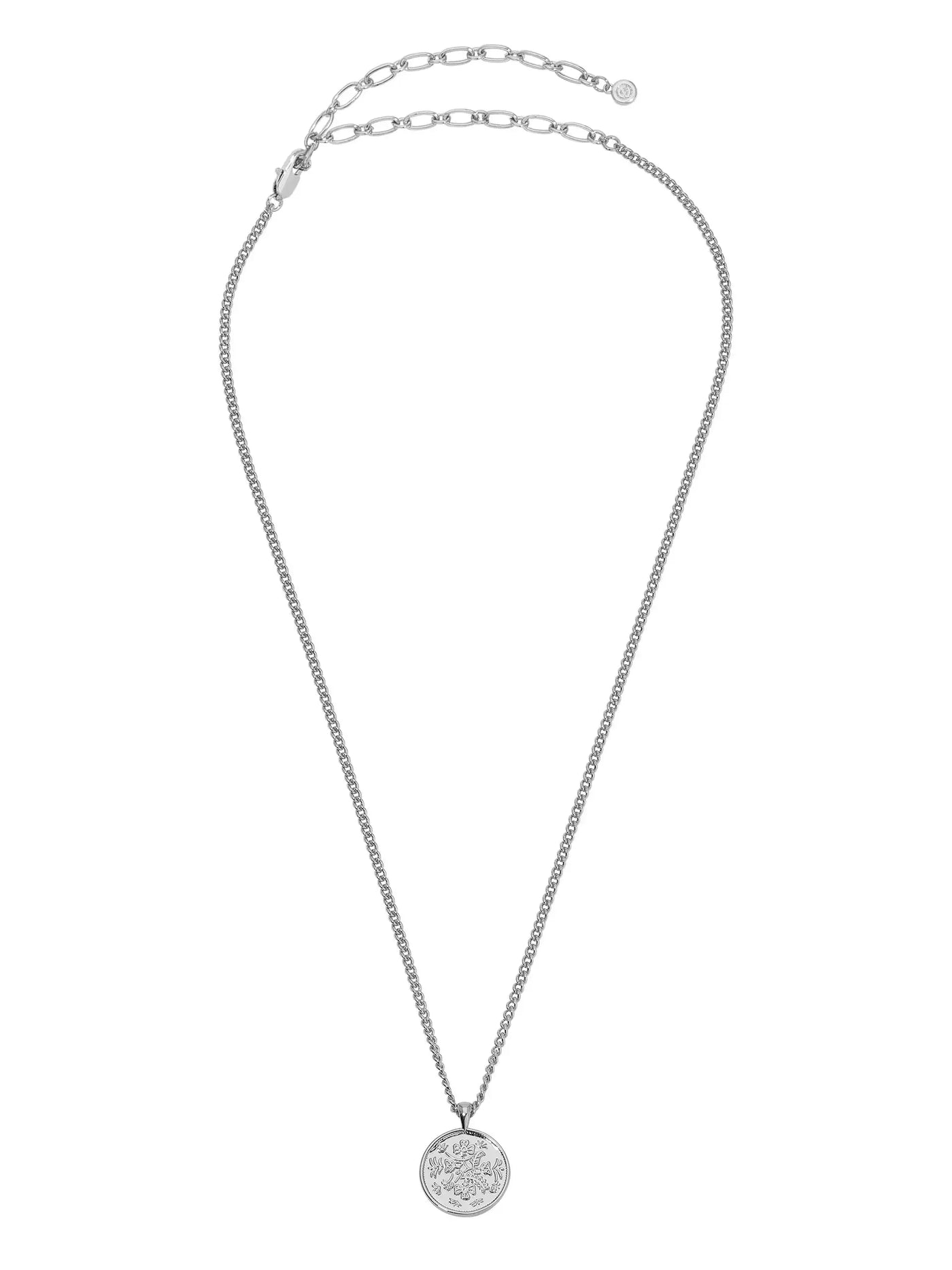 A silver necklace features a delicate chain with an adjustable clasp. The pendant is a round coin engraved with intricate floral designs, suspended at the center.