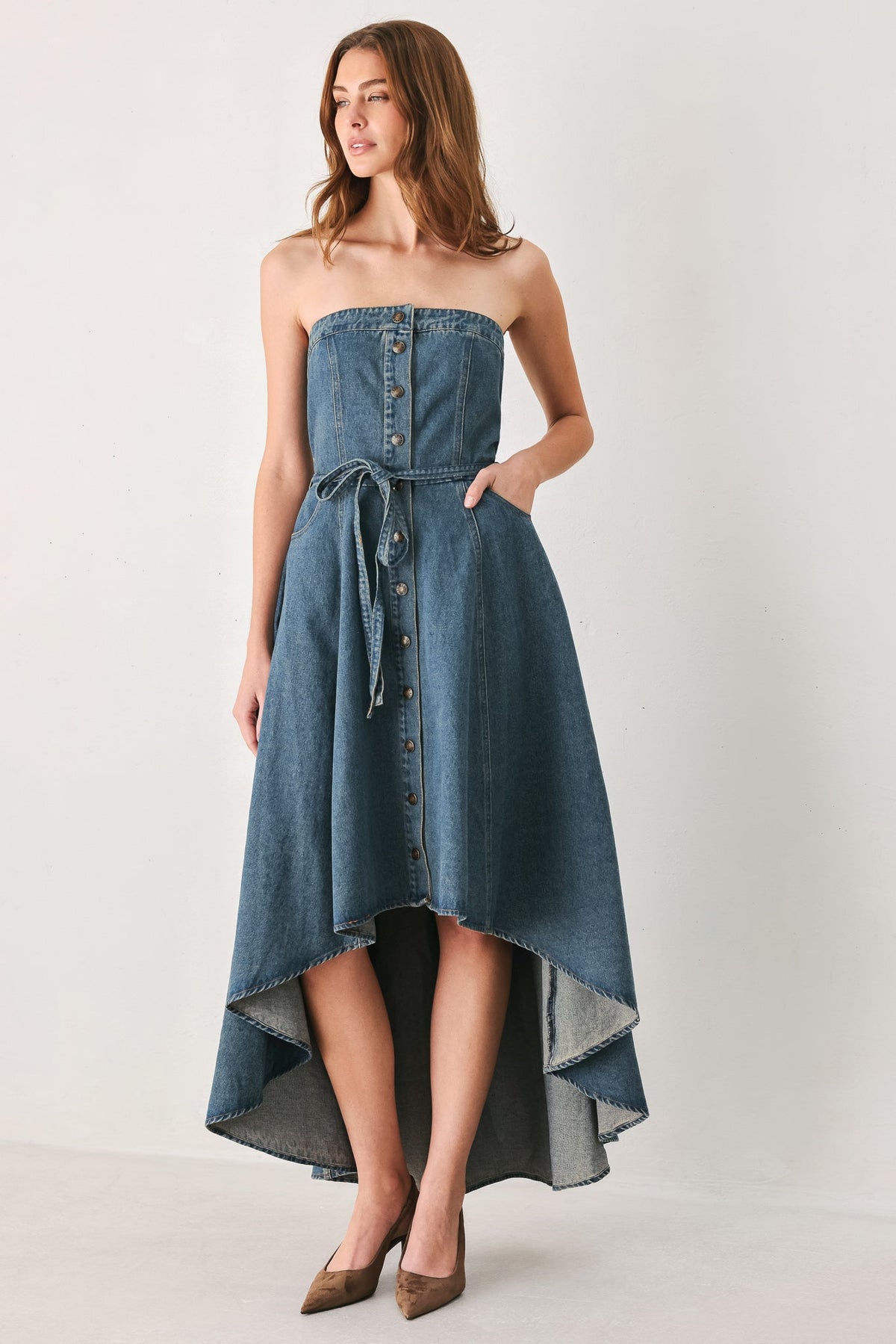 Strapless Button Front High Low Denim Midi Dress in Medium Indigo, front view with hand in pocket | Lady Black Tie