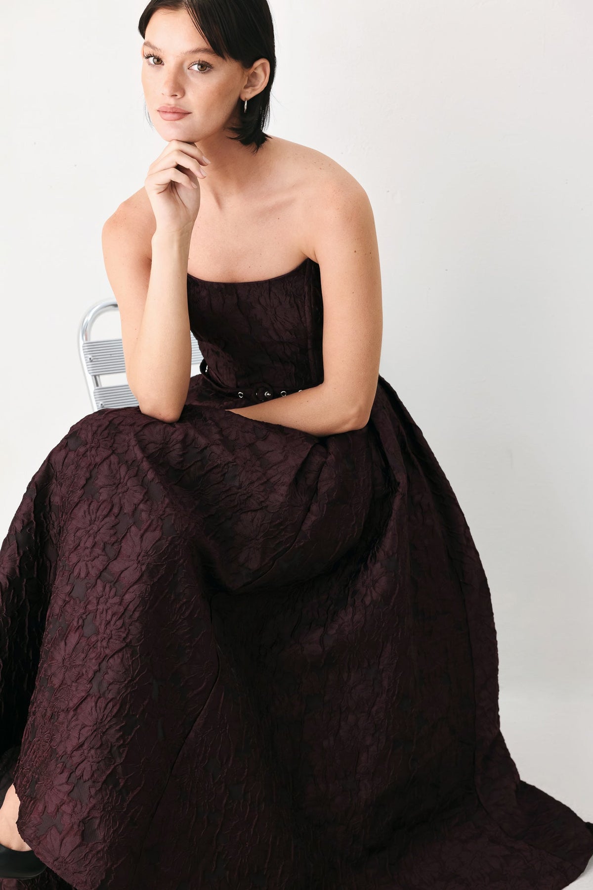 Burgundy Strapless Jacquard Midi Dress with Pockets in Burgundy, seated close-up | Lady Black Tie