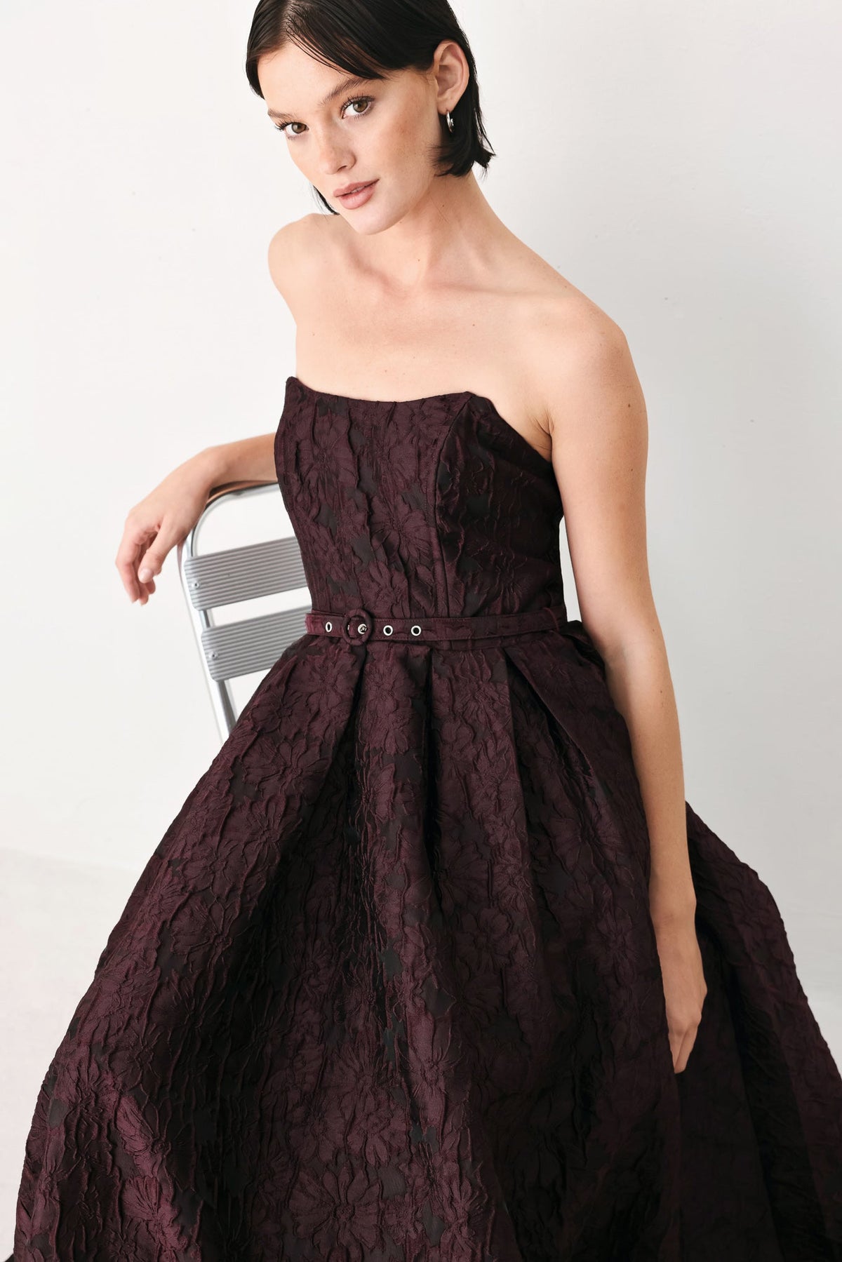 Burgundy Strapless Jacquard Midi Dress with Pockets in Burgundy, seated view | Lady Black Tie