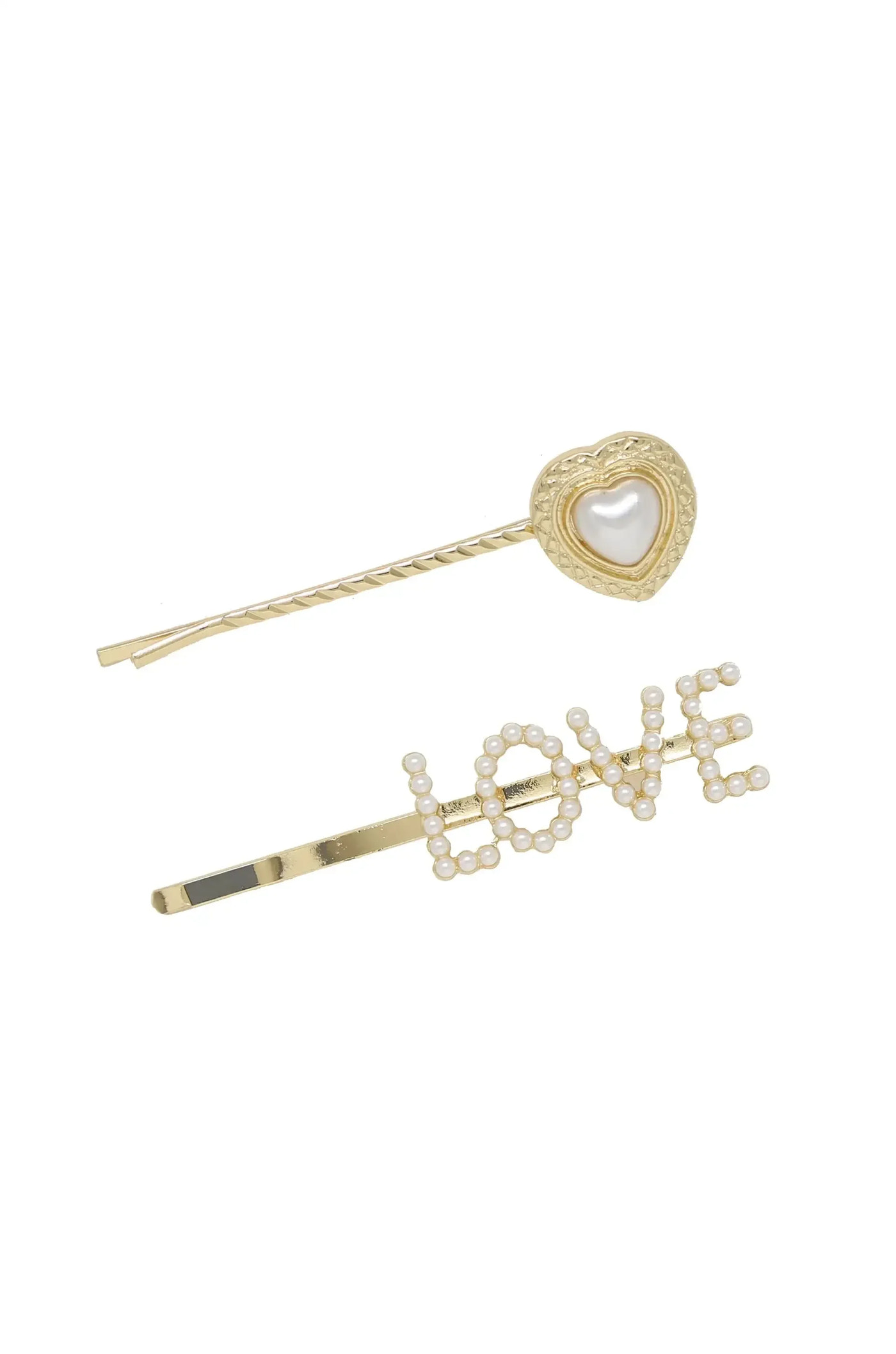 Two decorative hairpins lie against a white background. One is gold with a heart design featuring a pearl centerpiece, while the other spells "LOVE" in pearls on a gold bar.