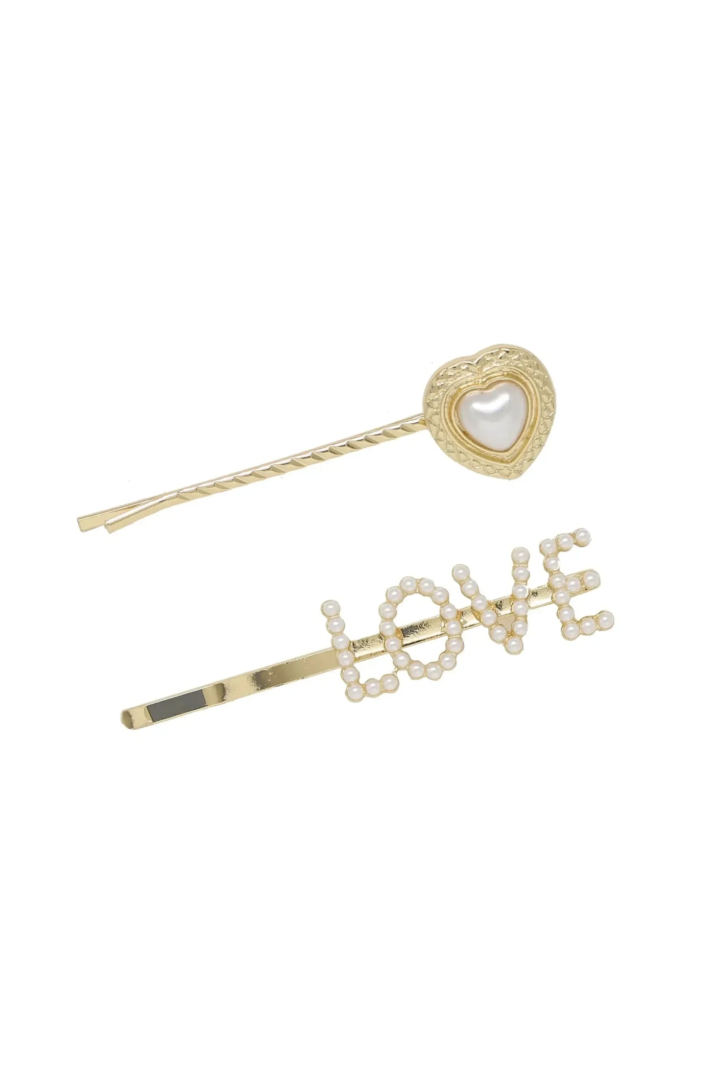 Two decorative hairpins lie against a white background. One is gold with a heart design featuring a pearl centerpiece, while the other spells "LOVE" in pearls on a gold bar.