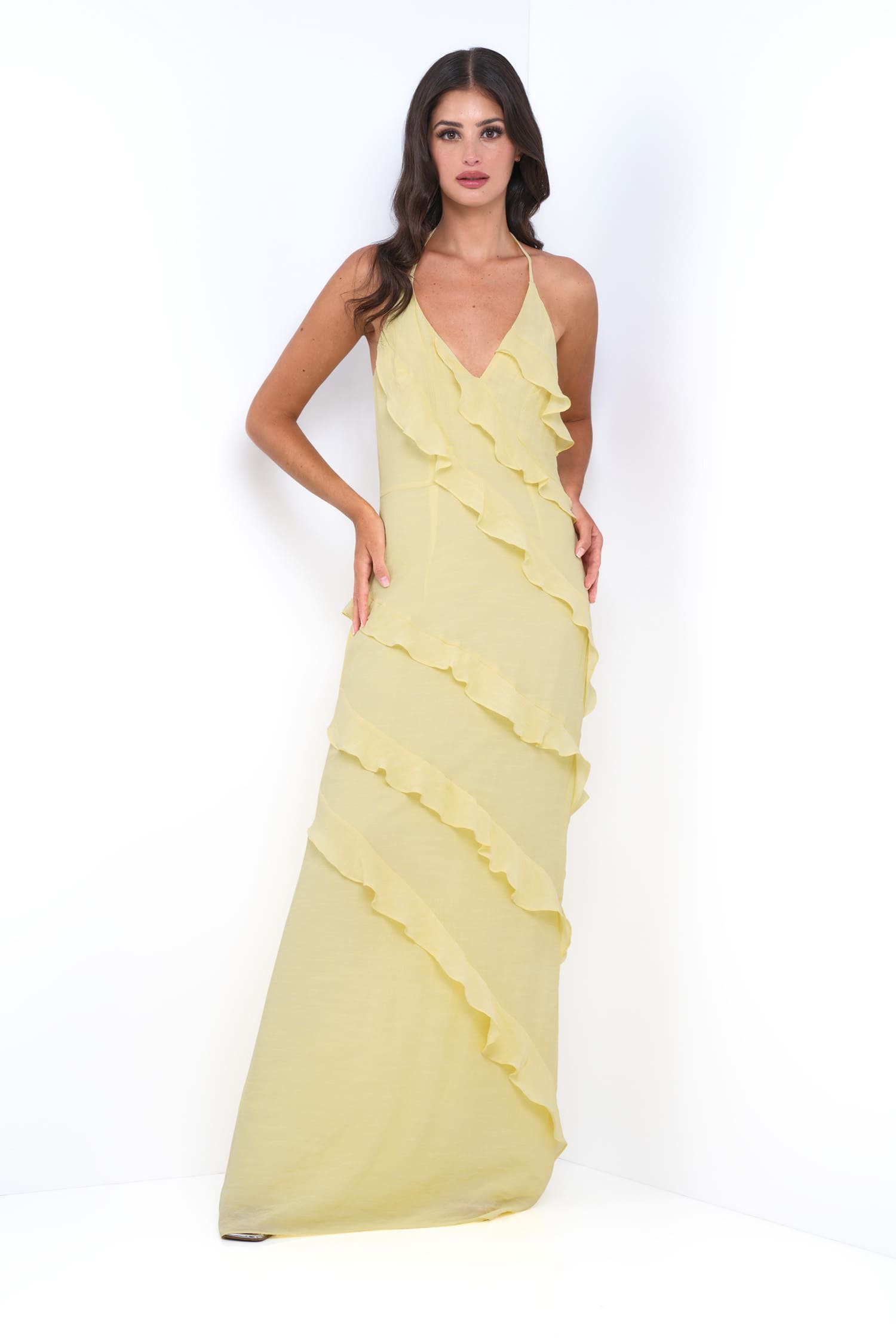 Woman wearing a yellow evening gown on a white background