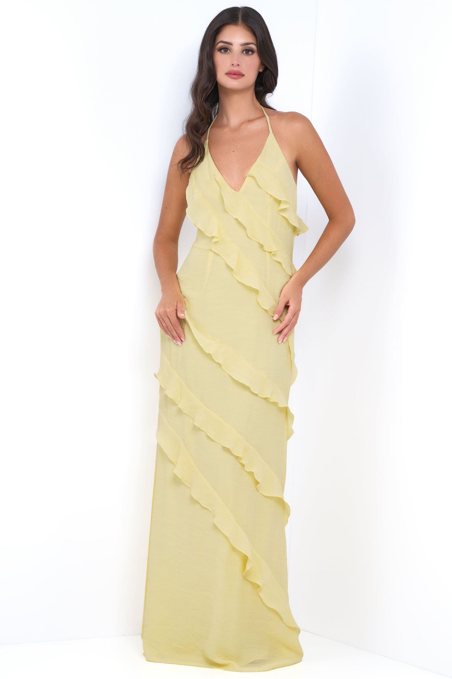 Woman wearing a yellow evening gown on a white background